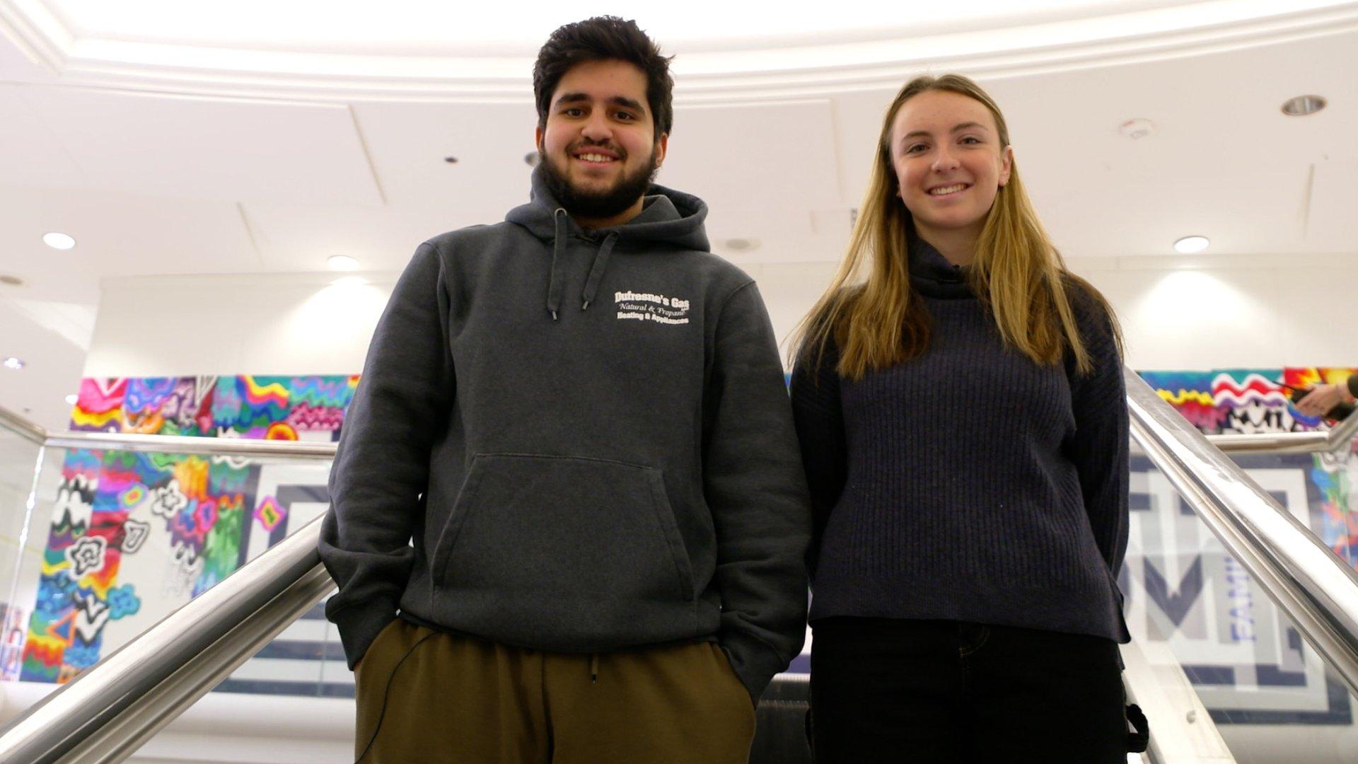 Two students on an escalator