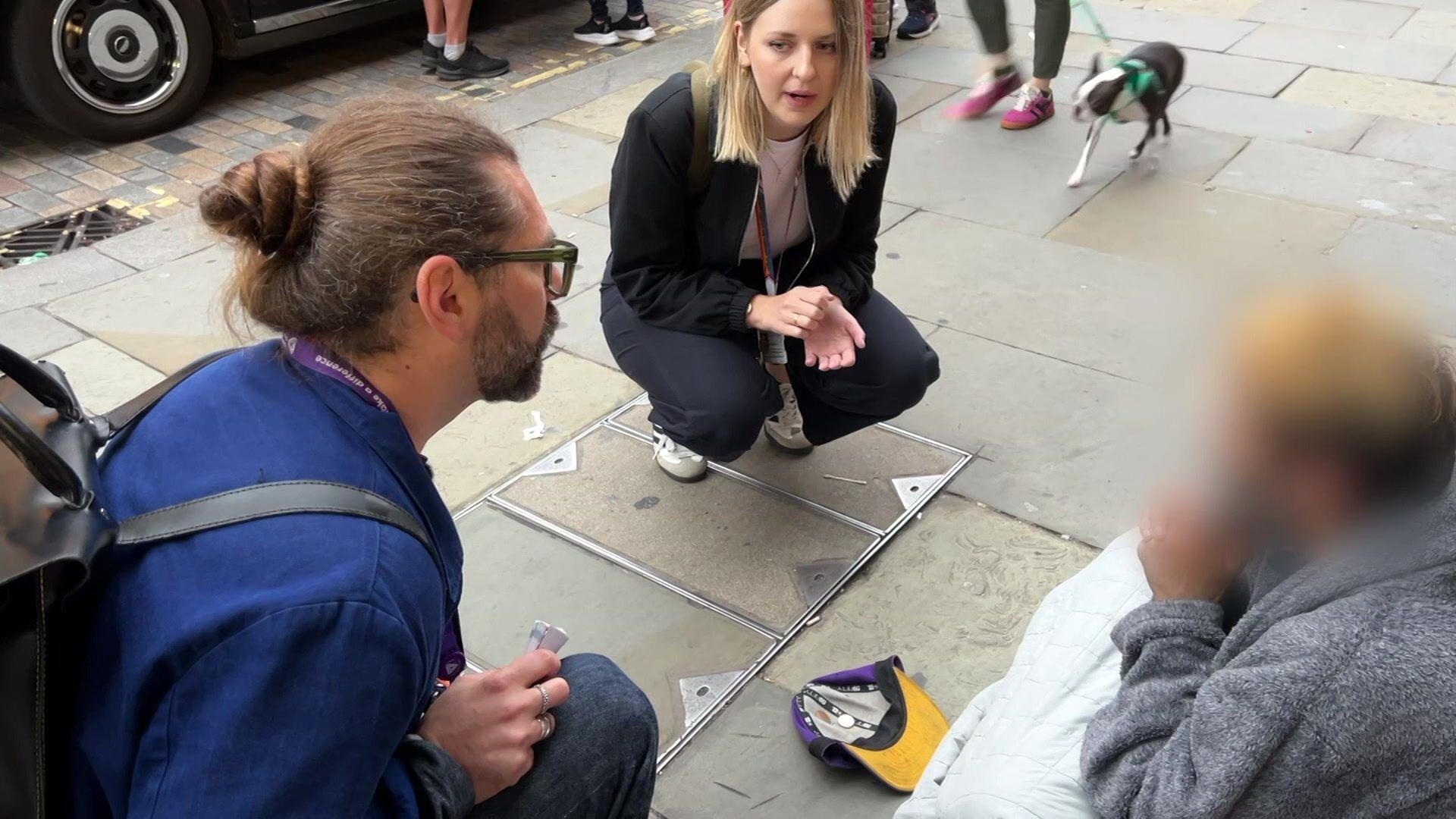 A man begging outside a station speaks to the outreach team