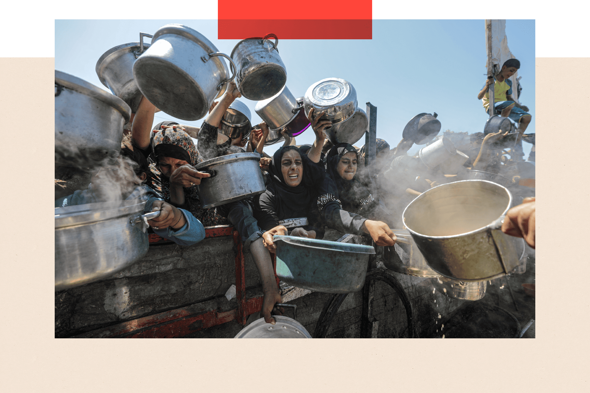 Displaced Palestinians hold pots as they receive food from a charity kitchen in Gaza City