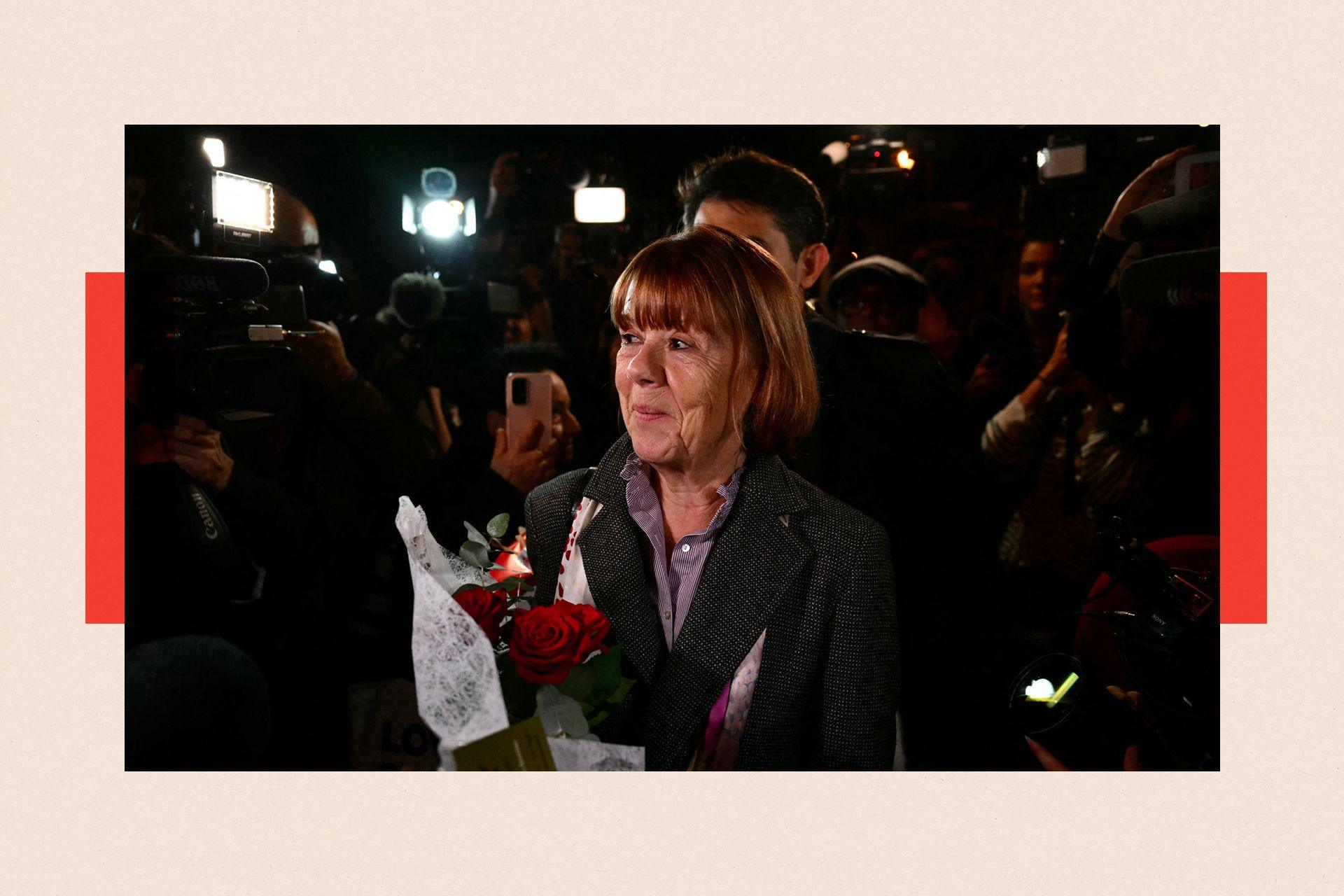 Gisèle Pelicot smiling and holding a bunch of red roses as she leaves the Avignon courthouse 