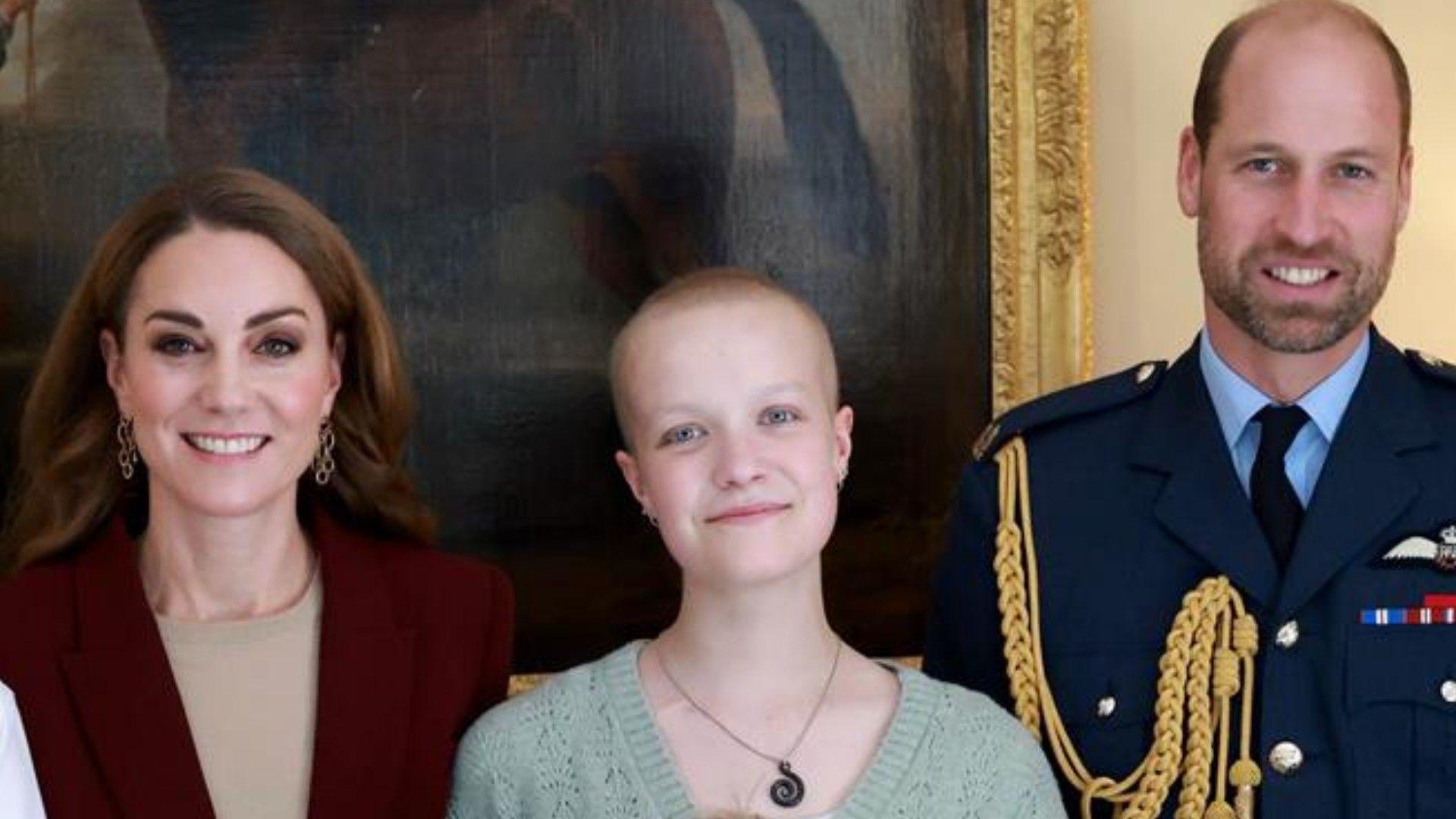 Liz Hatton, pictured with the Prince and Princess of Wales. The Princess, who is smiling at the camera, wears a burgundy blazer and beige top. She stands next to Ms Hatton, who is wearing a light green jumper and necklace.