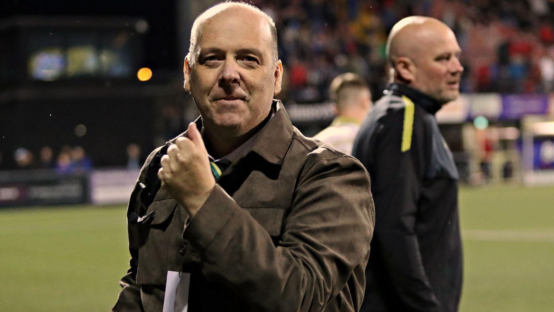 Caernarfon Town chairman Paul Evans celebrates after the win over Crusaders