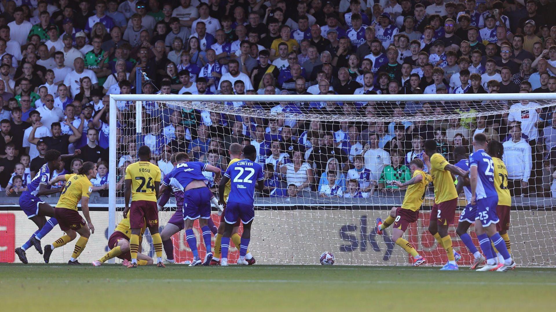 Bristol Rovers and Northampton players crowd the goalmouth at the Memorial Stadium as Rovers score