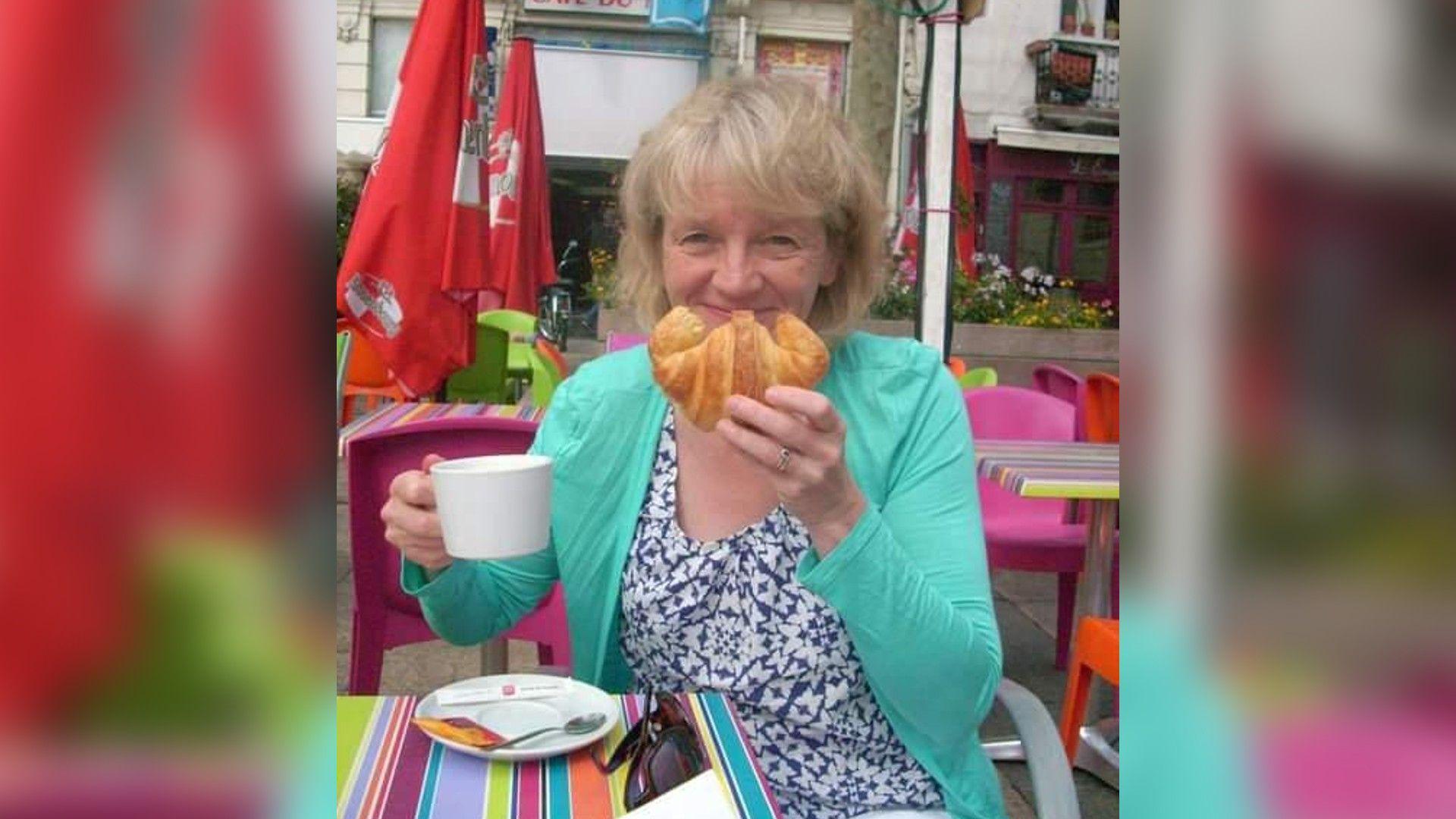 Julie Wilson eating a croissant on holiday