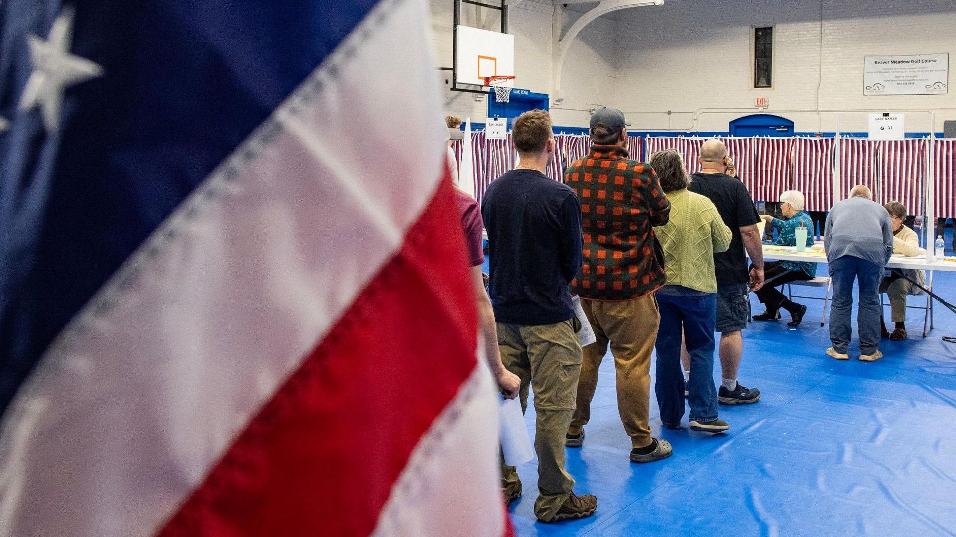 People wait in line to vote in Concord, New Hampshire.