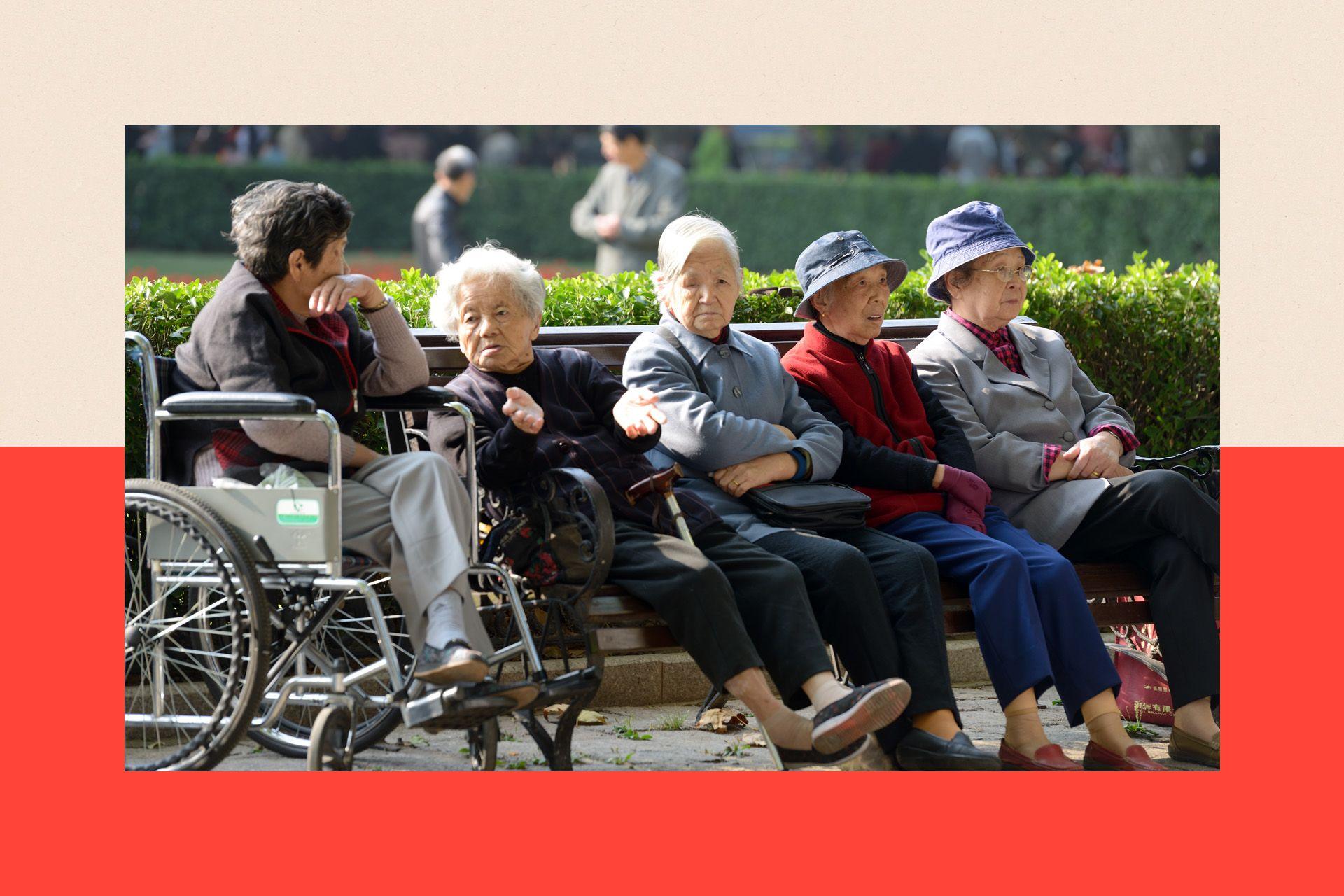 A group of elderly women sit on a bench in Fuxing Park in Shanghai