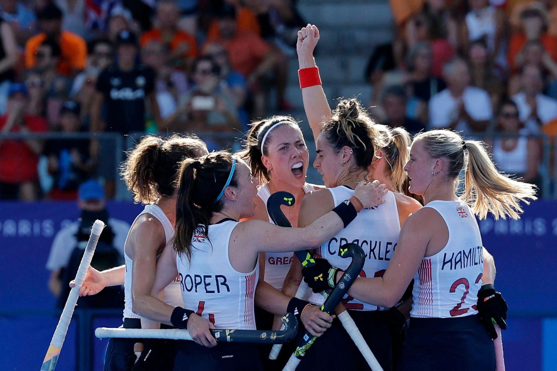 Laura Roper of Britain, Fiona Crackles of Britain and Sophie Hamilton of Britain celebrate with teammates their first goal