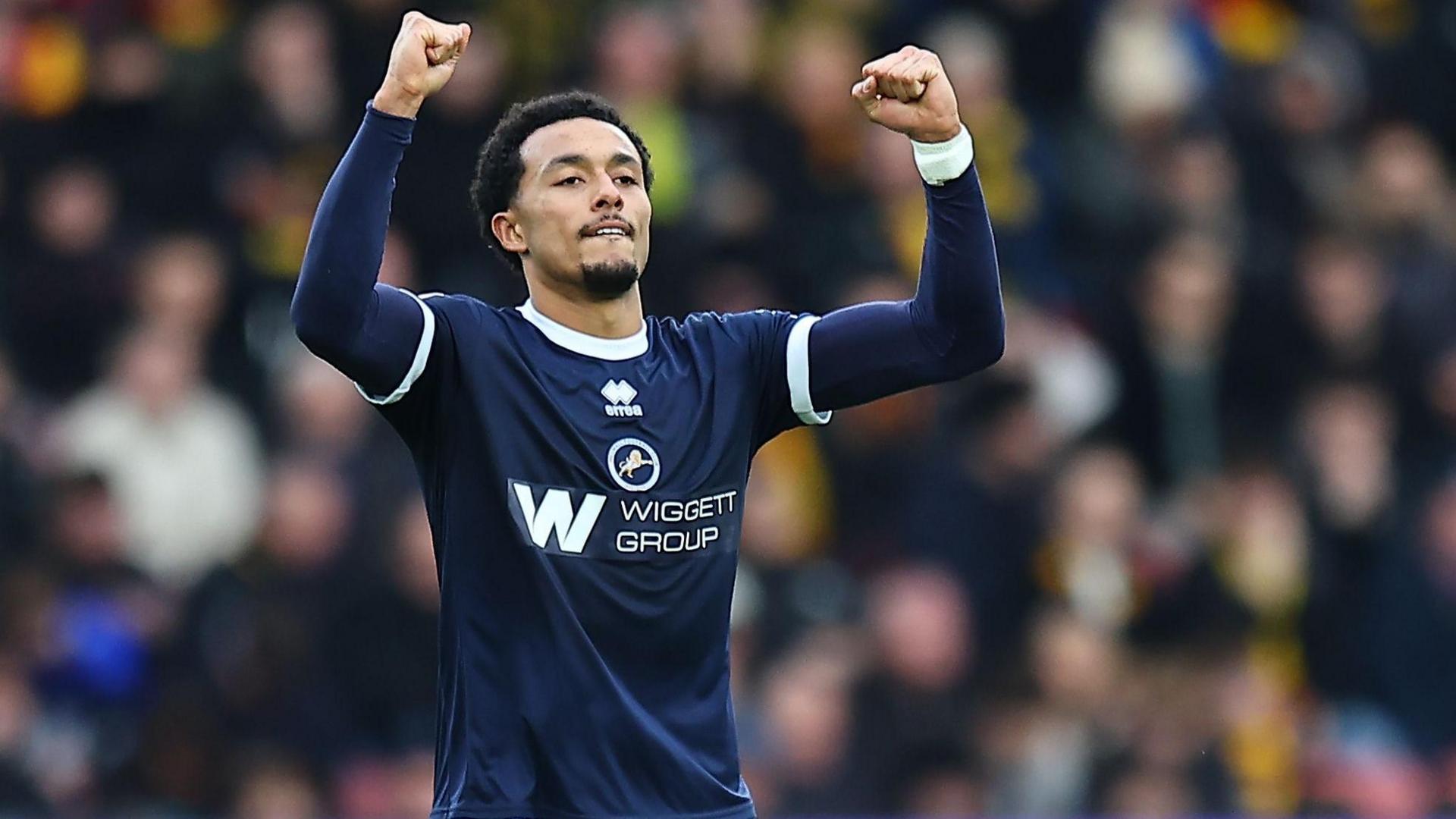 Femi Azeez celebrates with both arms raised