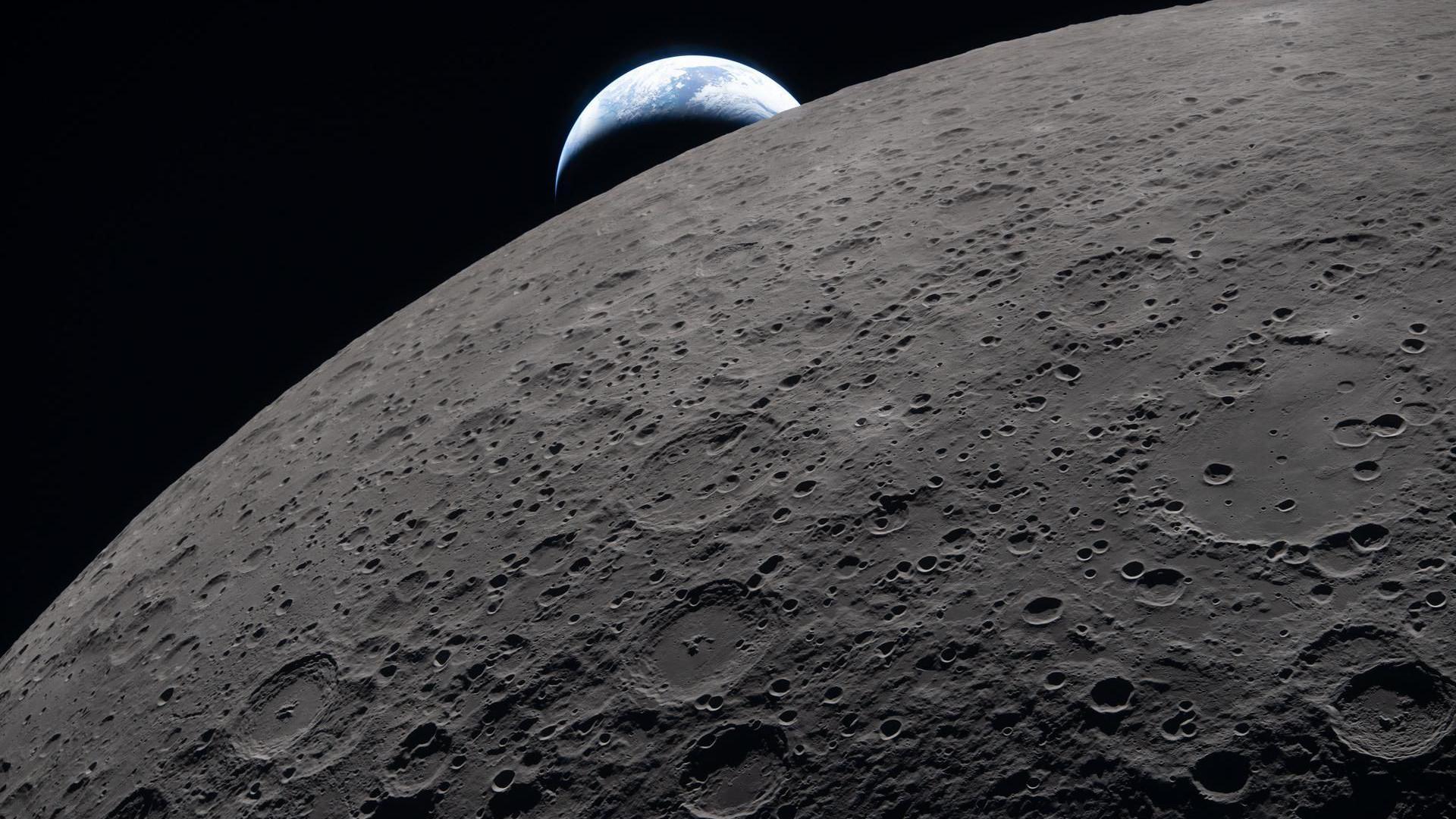 the Earth peeking out from behind the Moon