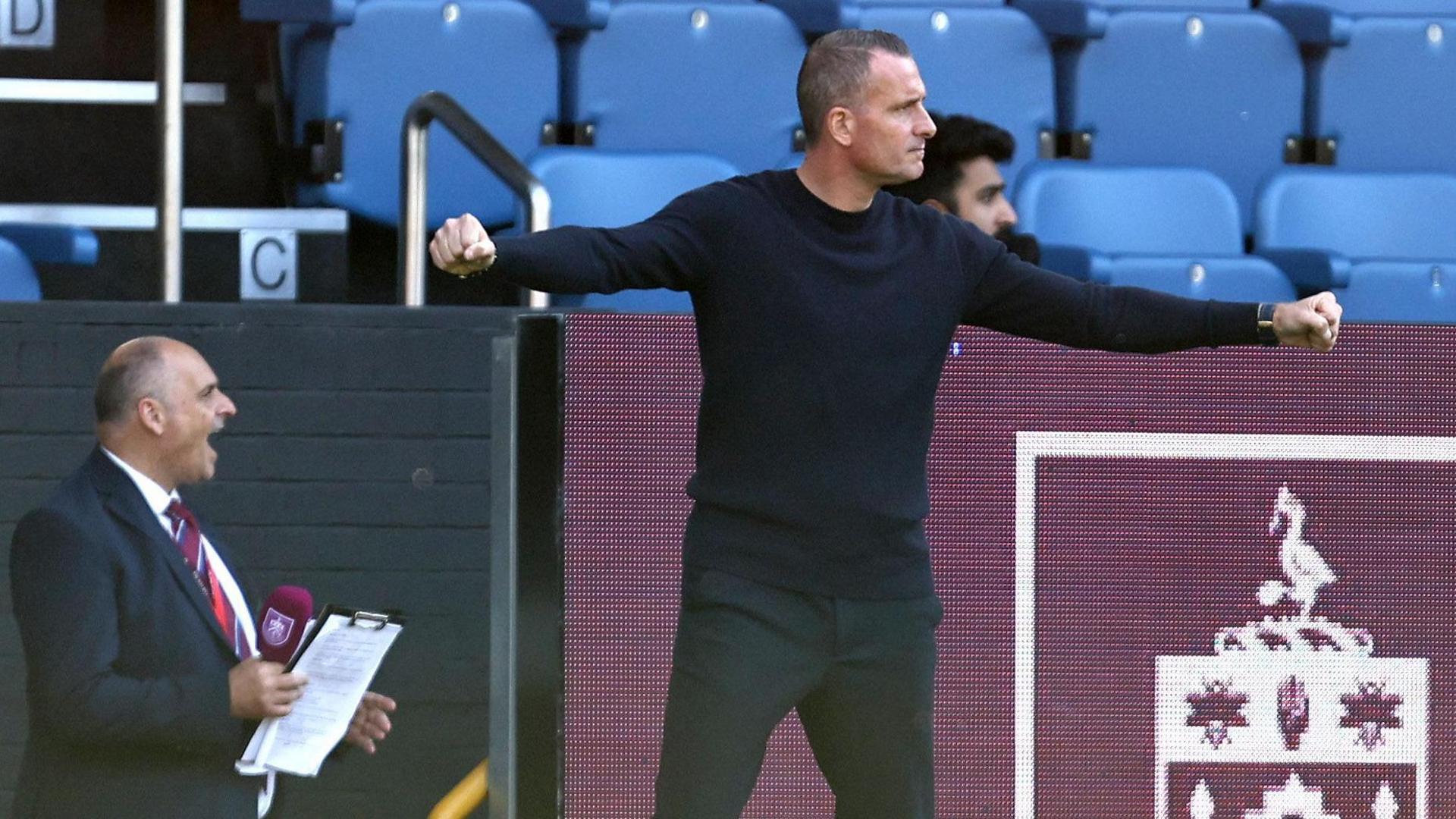 Nicky Hayen extends his arms with both fists clenches after Burnley equalise against Notts County