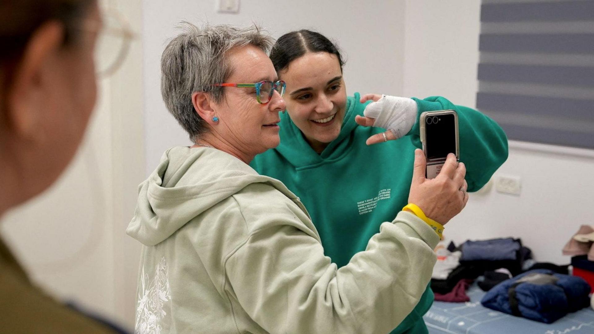 Hostage Emily Damari, an Israeli-British citizen, with her mother Mandy at an Israeli military base on Sunday after being released