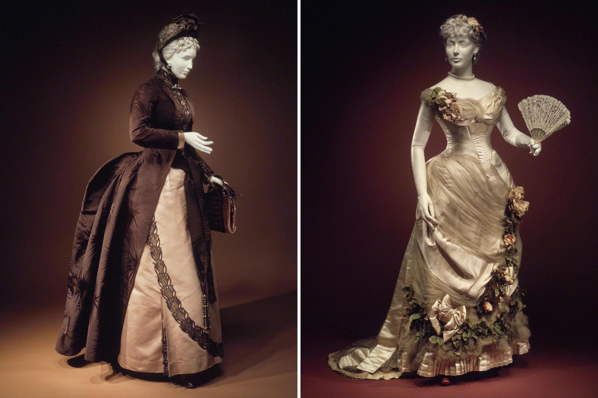 Two images of Victorian dresses on mannequins. The first is a brown and cream afternoon dress with matching hat and bag. The second is in a silver-cream evening dress with intricate ruffles and floral details, with matching fan.