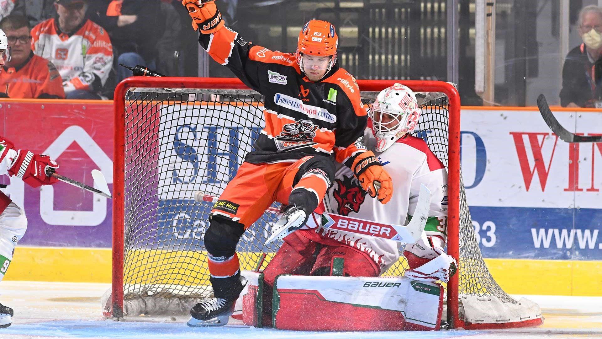 Sheffield Steelers player falls on Cardiff Devils netminder Mac Carruth