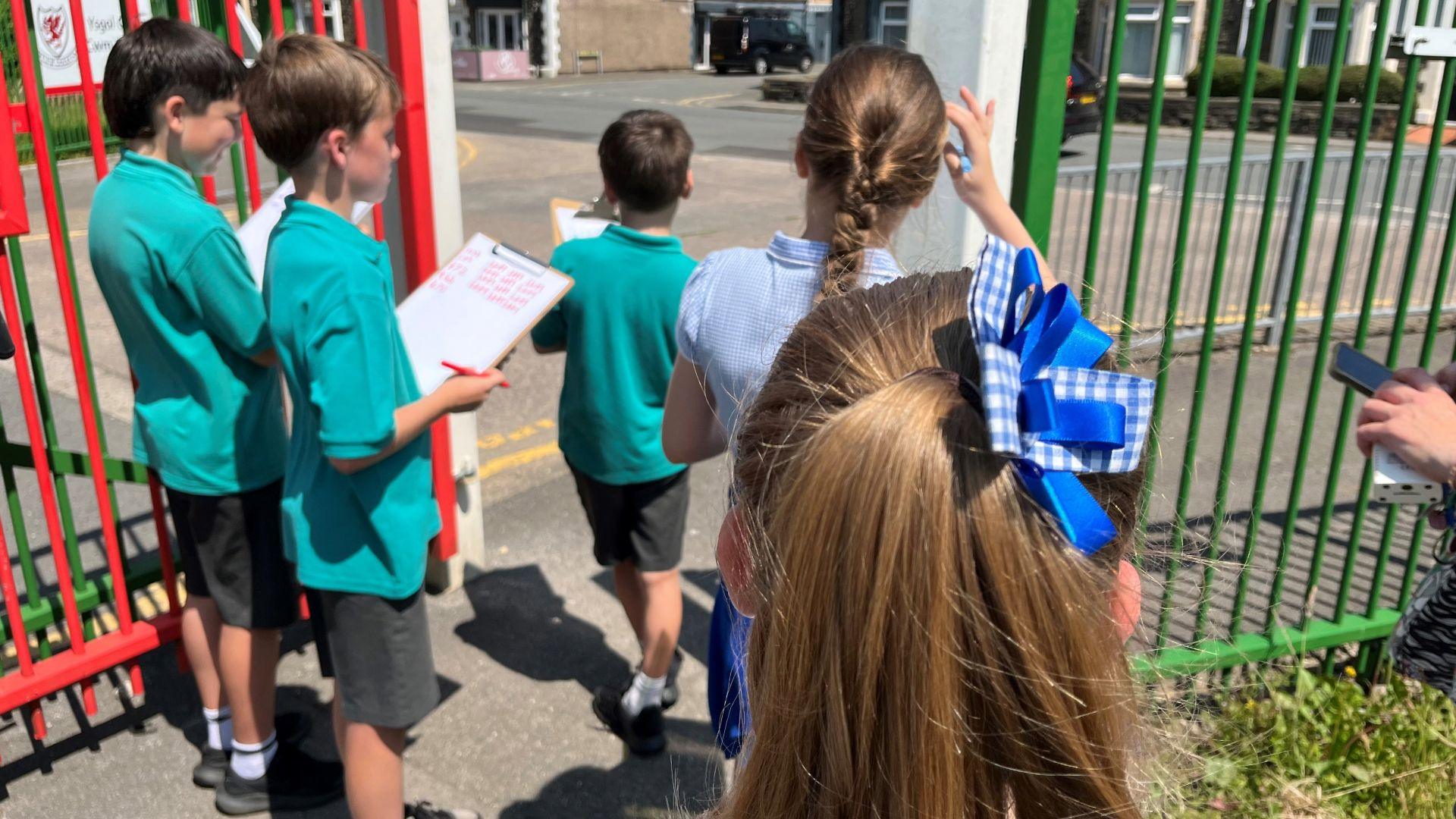 Llun o blant wrth giat Ysgol Gymraeg Caerffili yn mesur traffig