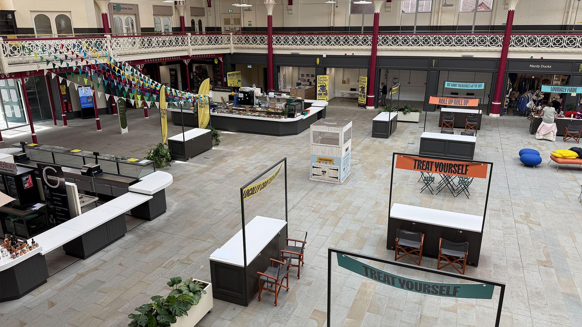 Above view of the new Market Hall in Derby, showing empty stalls, units and pop-up stalls and low footfall.