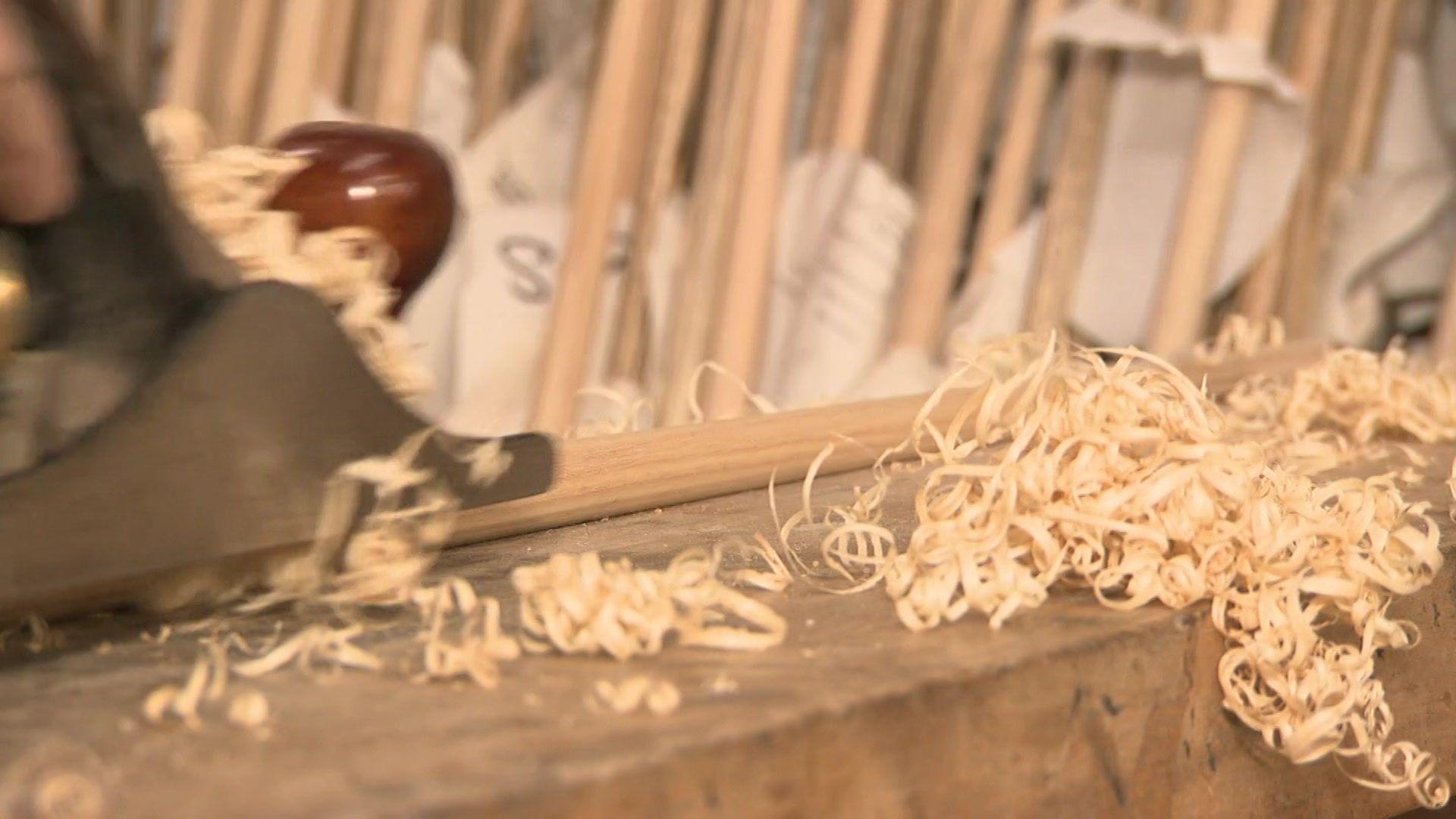 A snooker cue is planed by a worker at Parris Cues in South East London.
