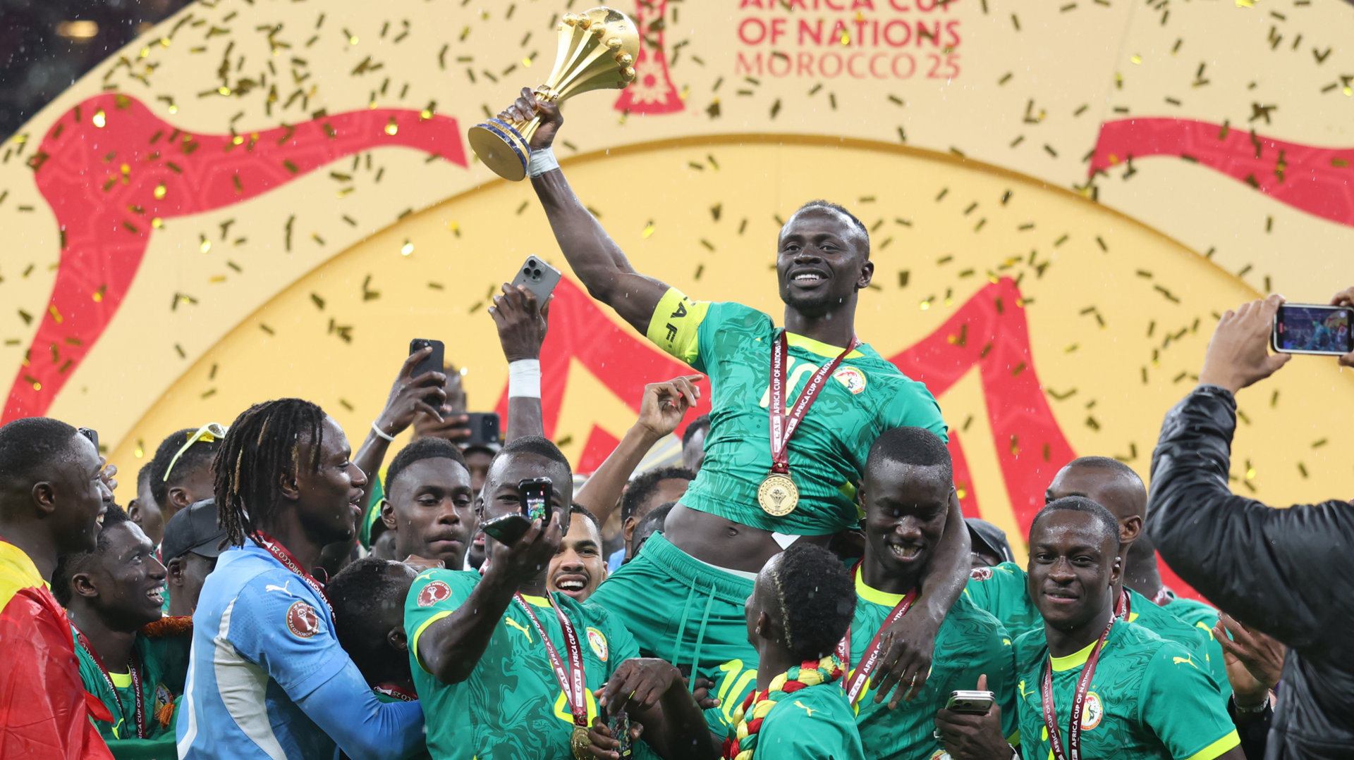 Senegalese players raise the Afcon trophy