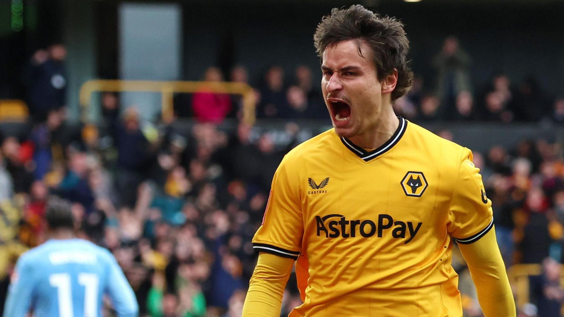 Hugo Bueno celebrates scoring a goal for Wolves