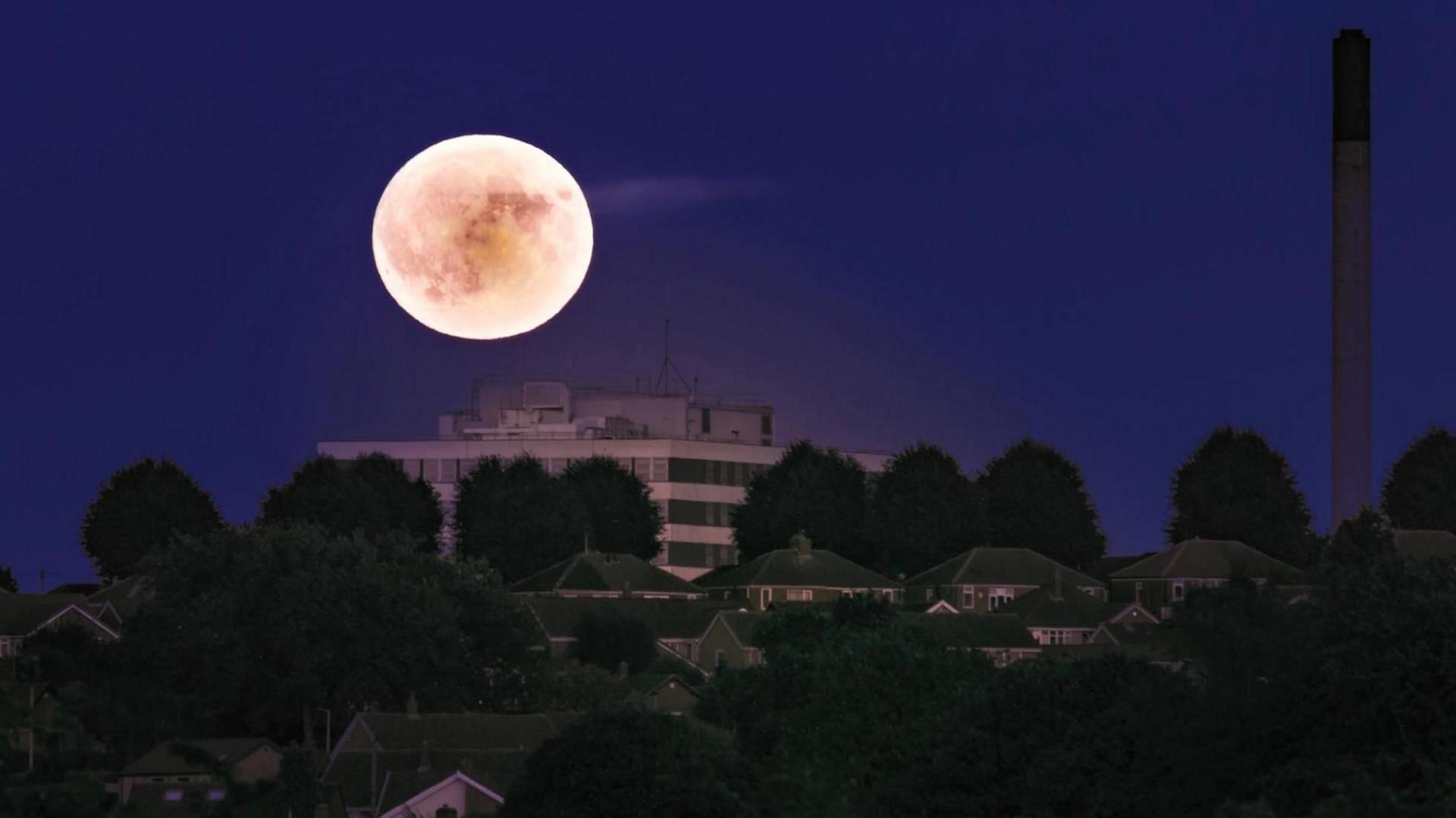 The moon shines over buildings in Barnsley.