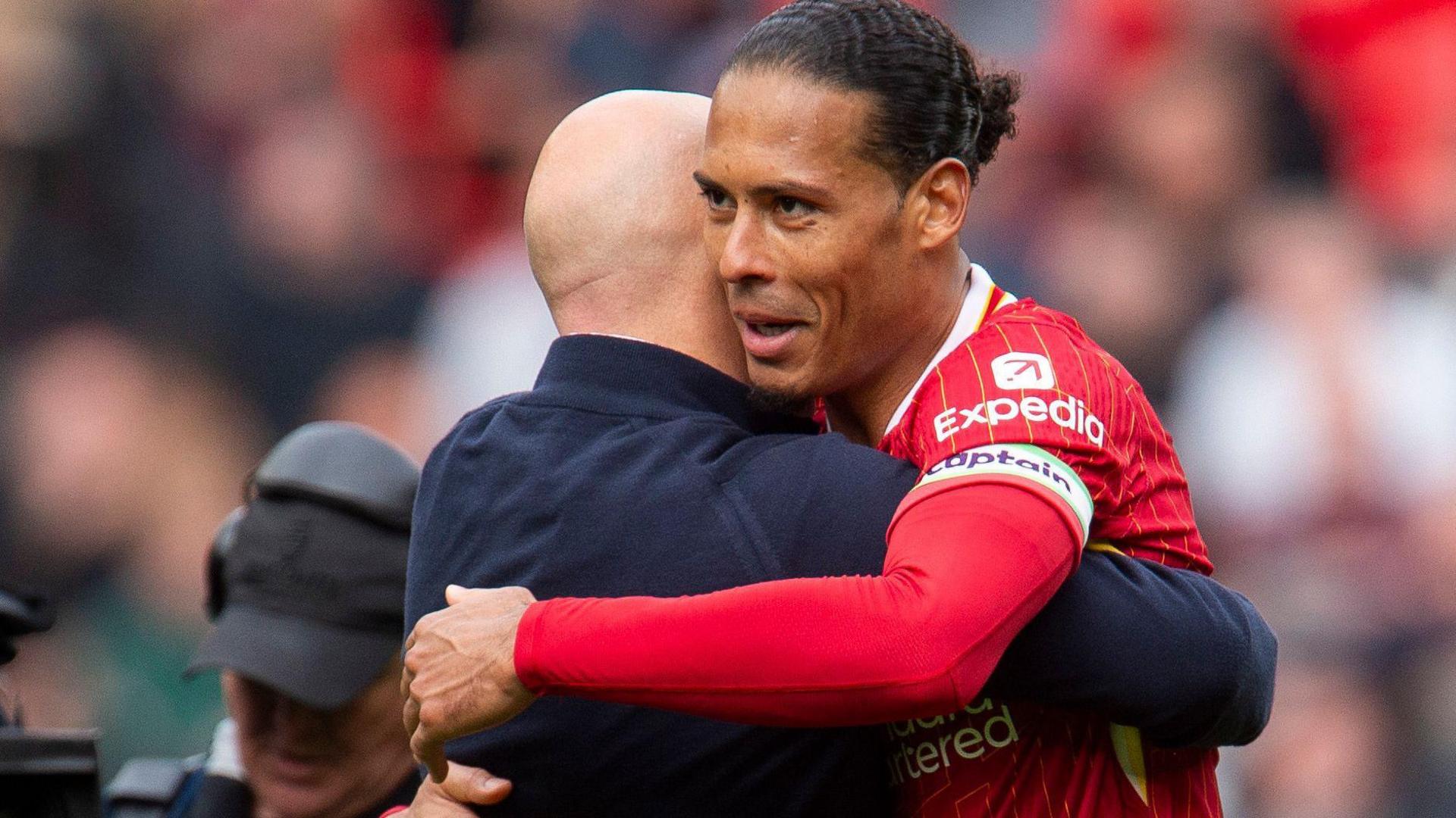 Liverpool boss Arne Slot embraces Virgil van Dijk