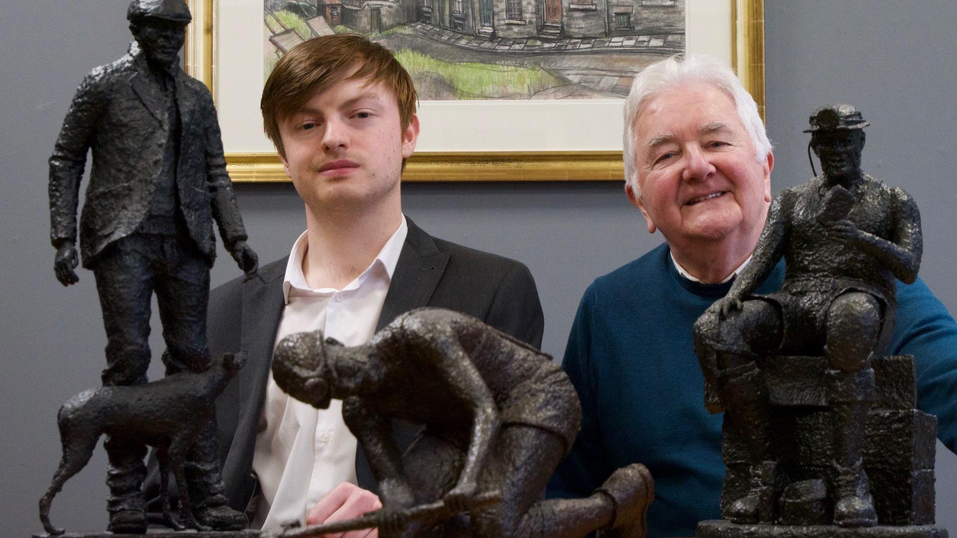 Michael Hanwell, grandson of artist Terry Parks, and gallery manager John Thompson with three of the black miniature miners.