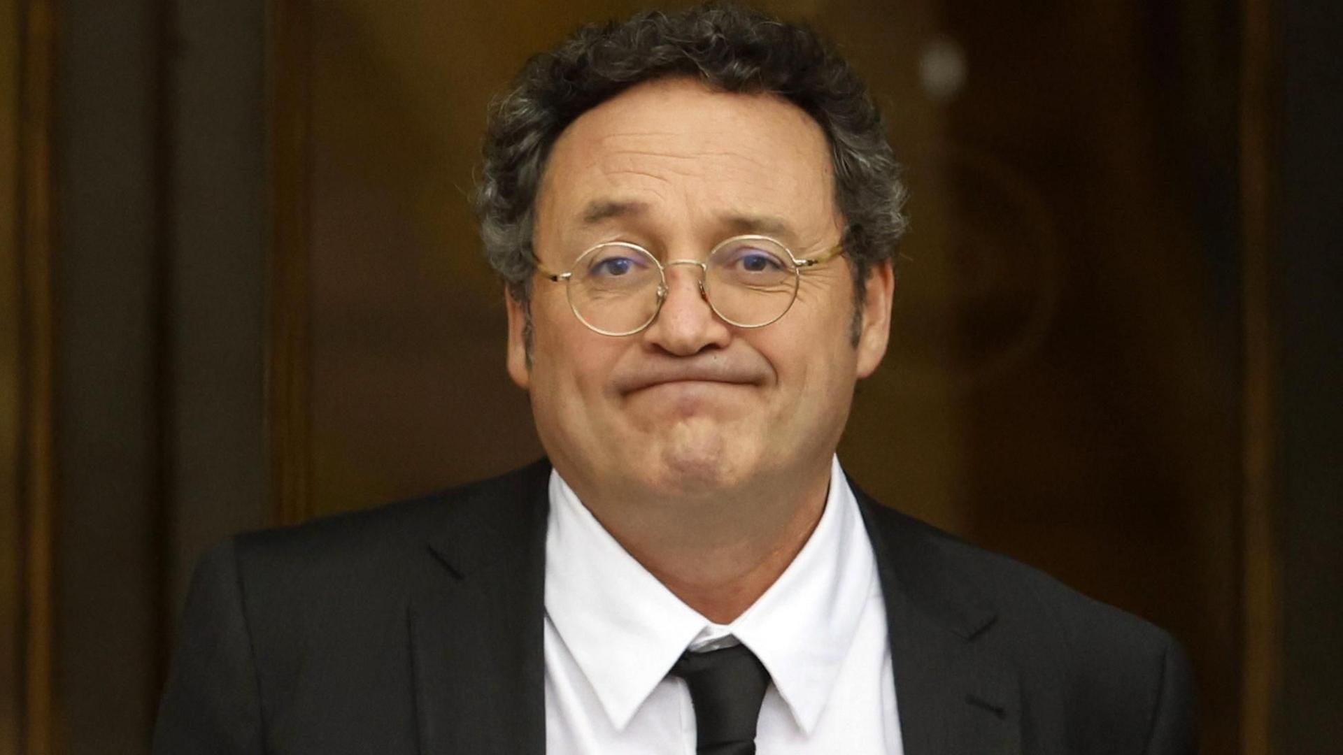 Spanish State Attorney General Alvaro Garcia Ortiz leaves after appearing at the Supreme Court in Madrid. He wears a a dark blazer, white shirt and tie. 