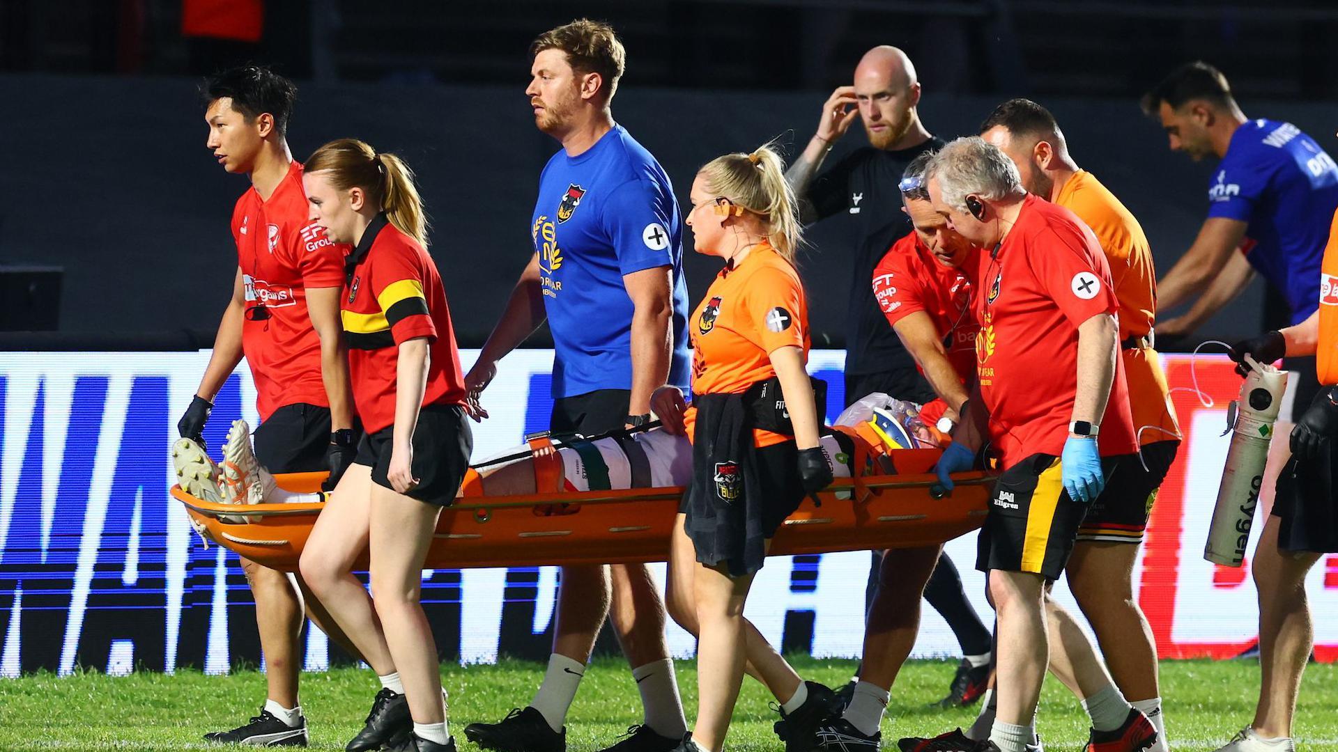 Bradford Bulls forward Will Gardiner is stretchered from the field by medical teams
