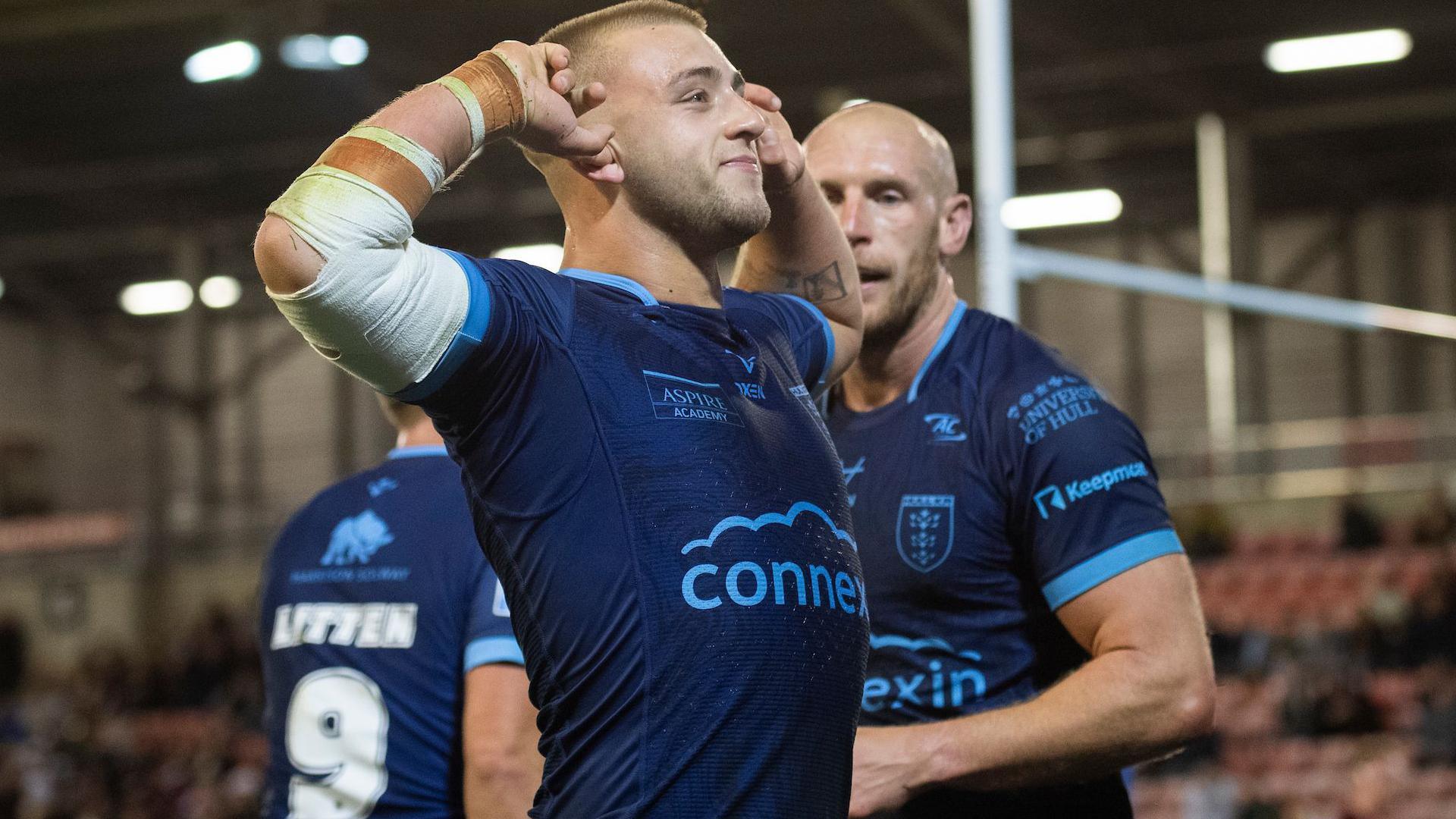 Mikey Lewis puts his hands to his ears to soak up the boos as he celebrates a Hull KR try in front of the Leigh fans