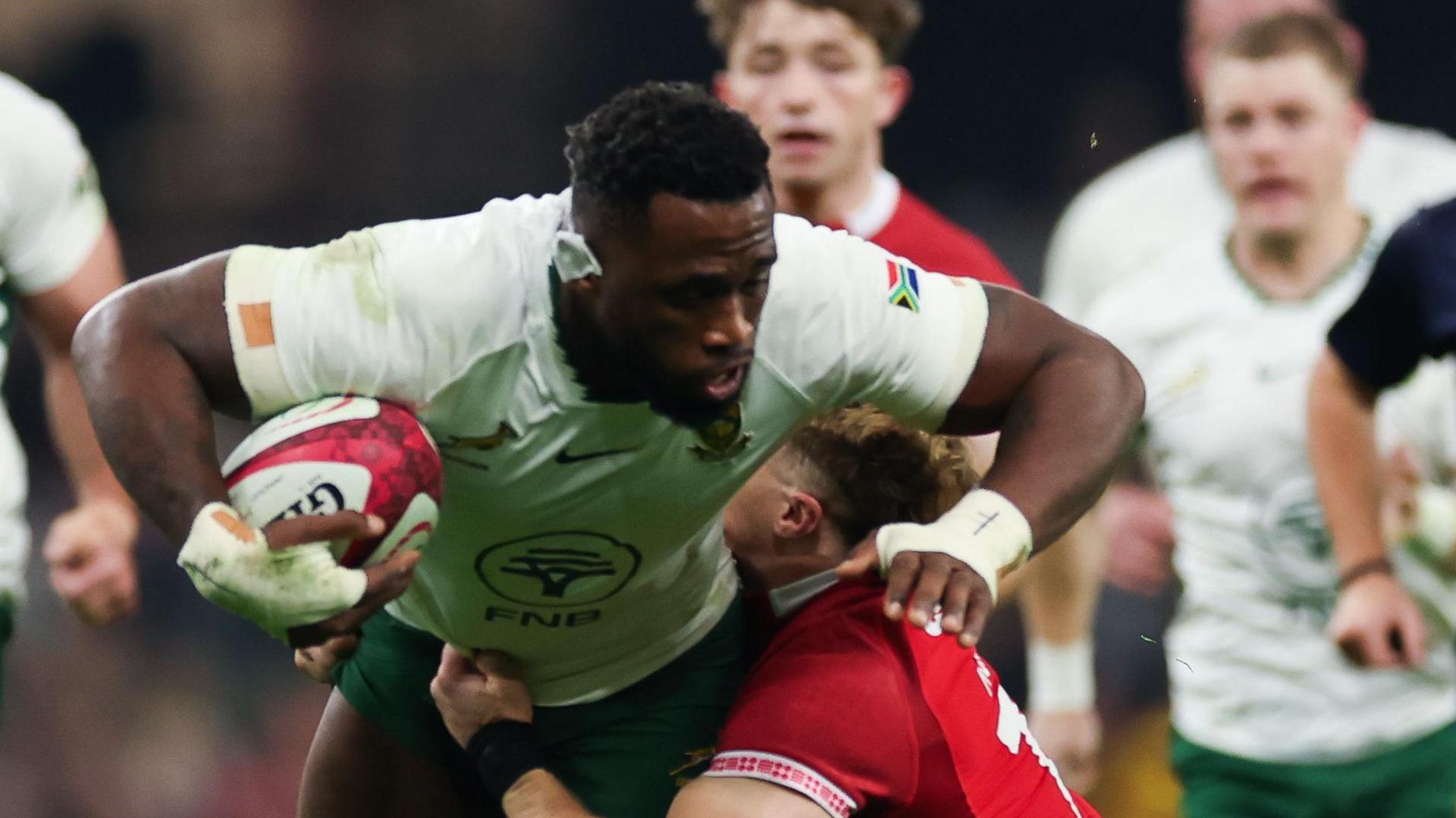 Siya Kolisi powers through a tackle from Cardiff flanker Alex Mann