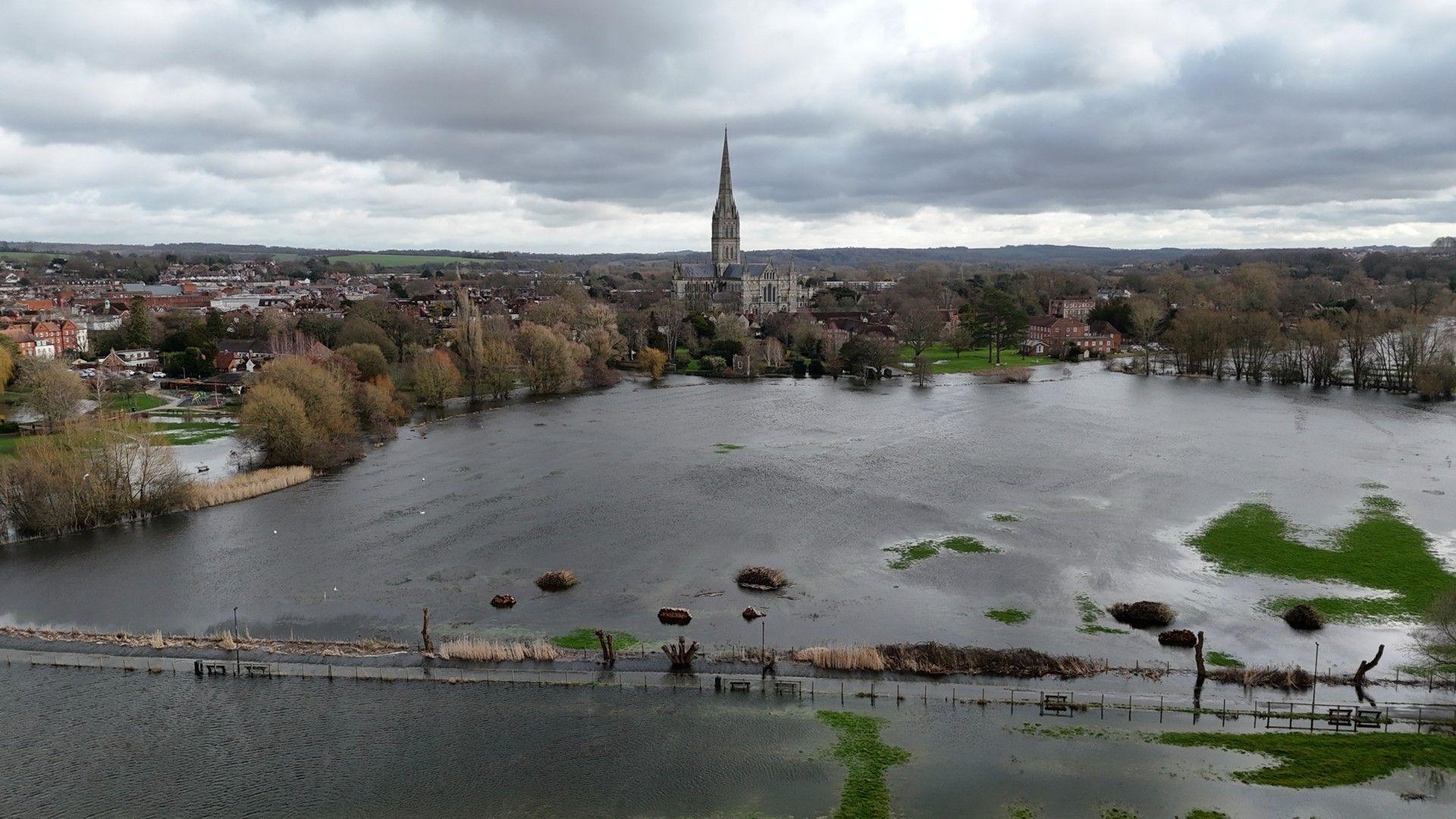 Aerial view of Salisbury showing extensive flooding in the foreground and Salisbury Cathedral in the background
