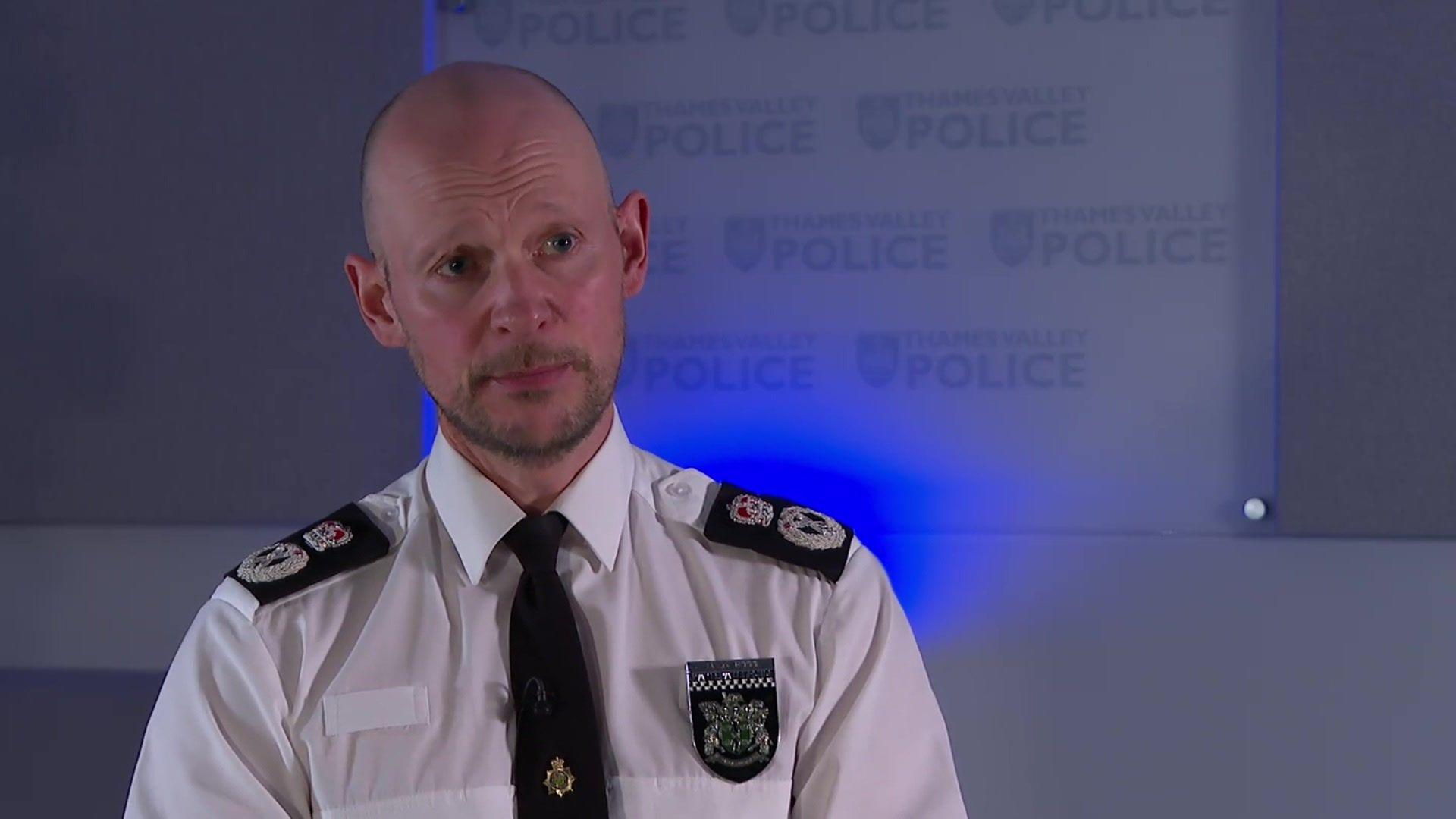 Chief Police Constable Jason Hogg is in a shirt and tie in front of a wall with the Thames Valley Police logo on.