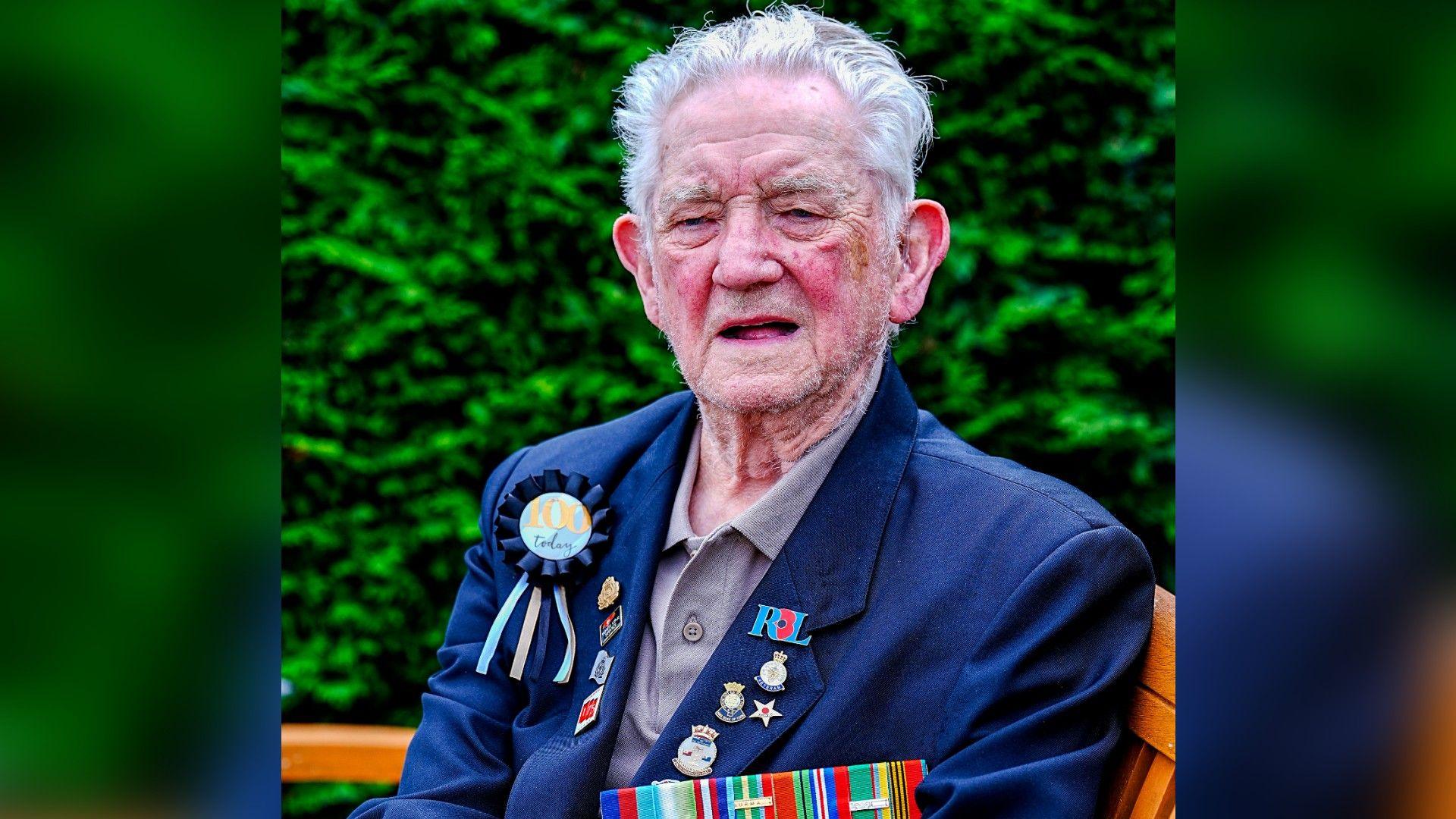 Veteran Reg Draper sat down wearing a smart blue blazer and tshirt wearing his war medals 