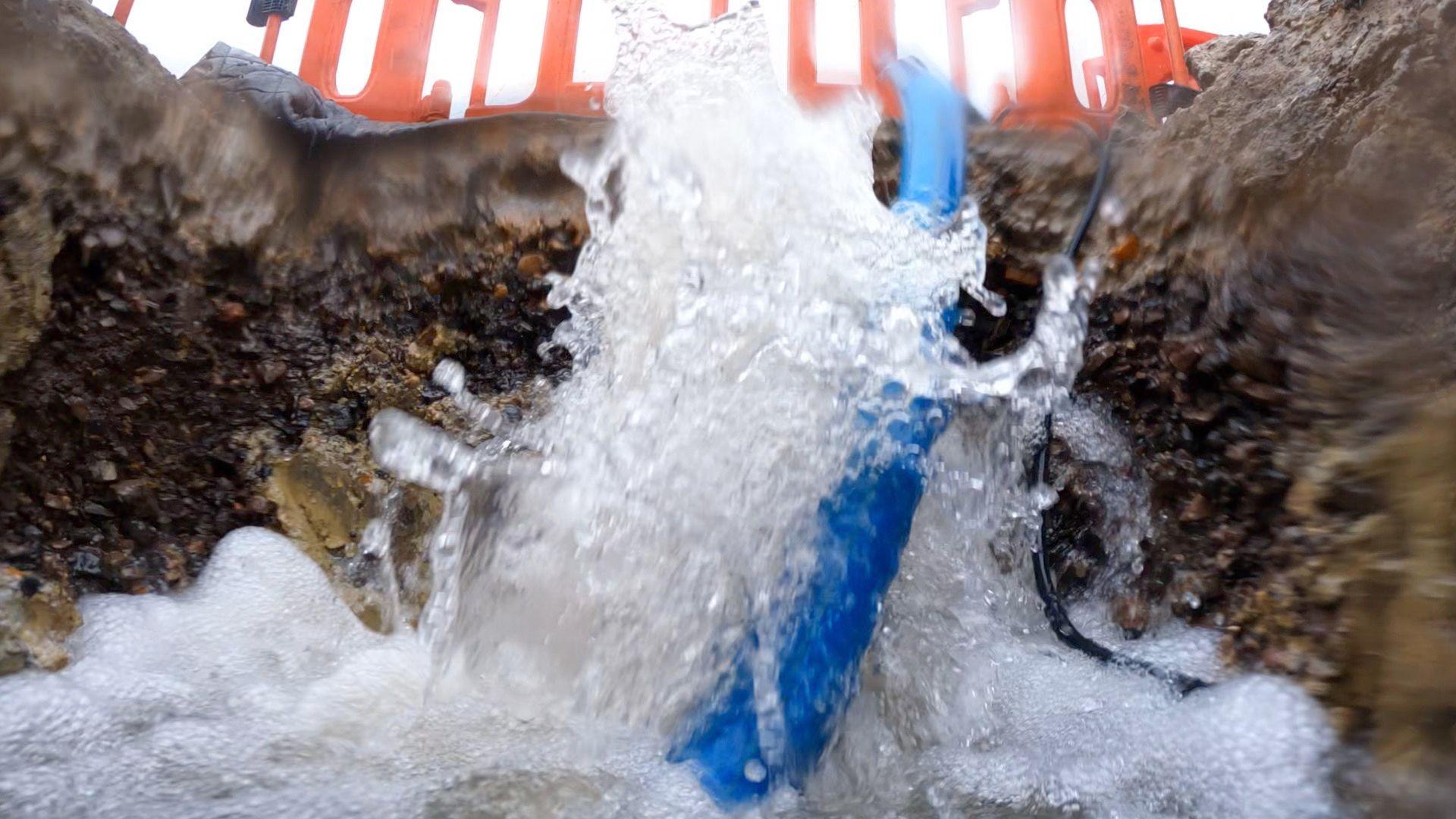 Water gushing out of a burst pipe