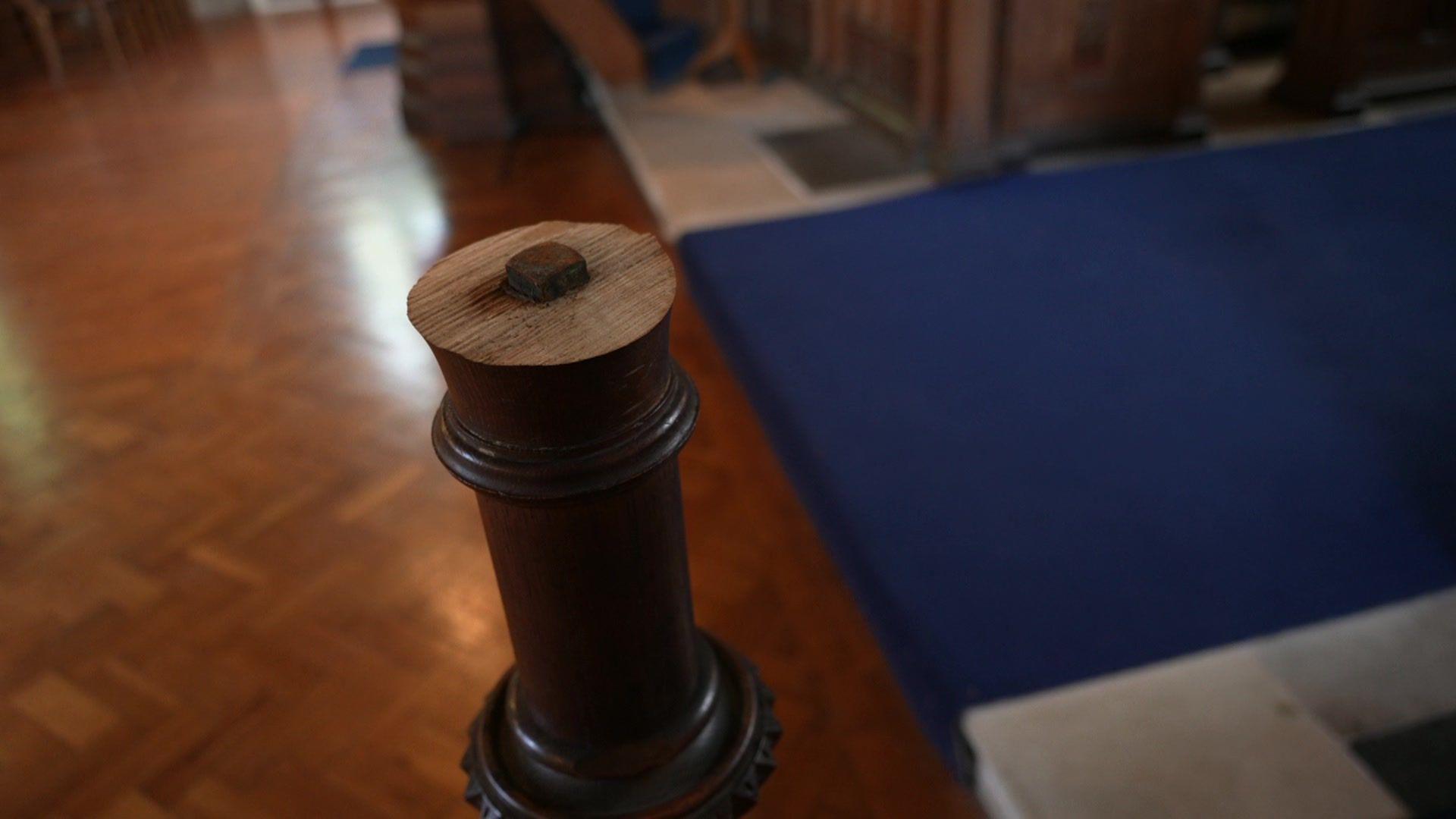 A wooden lectern post which has had the top sawn off.