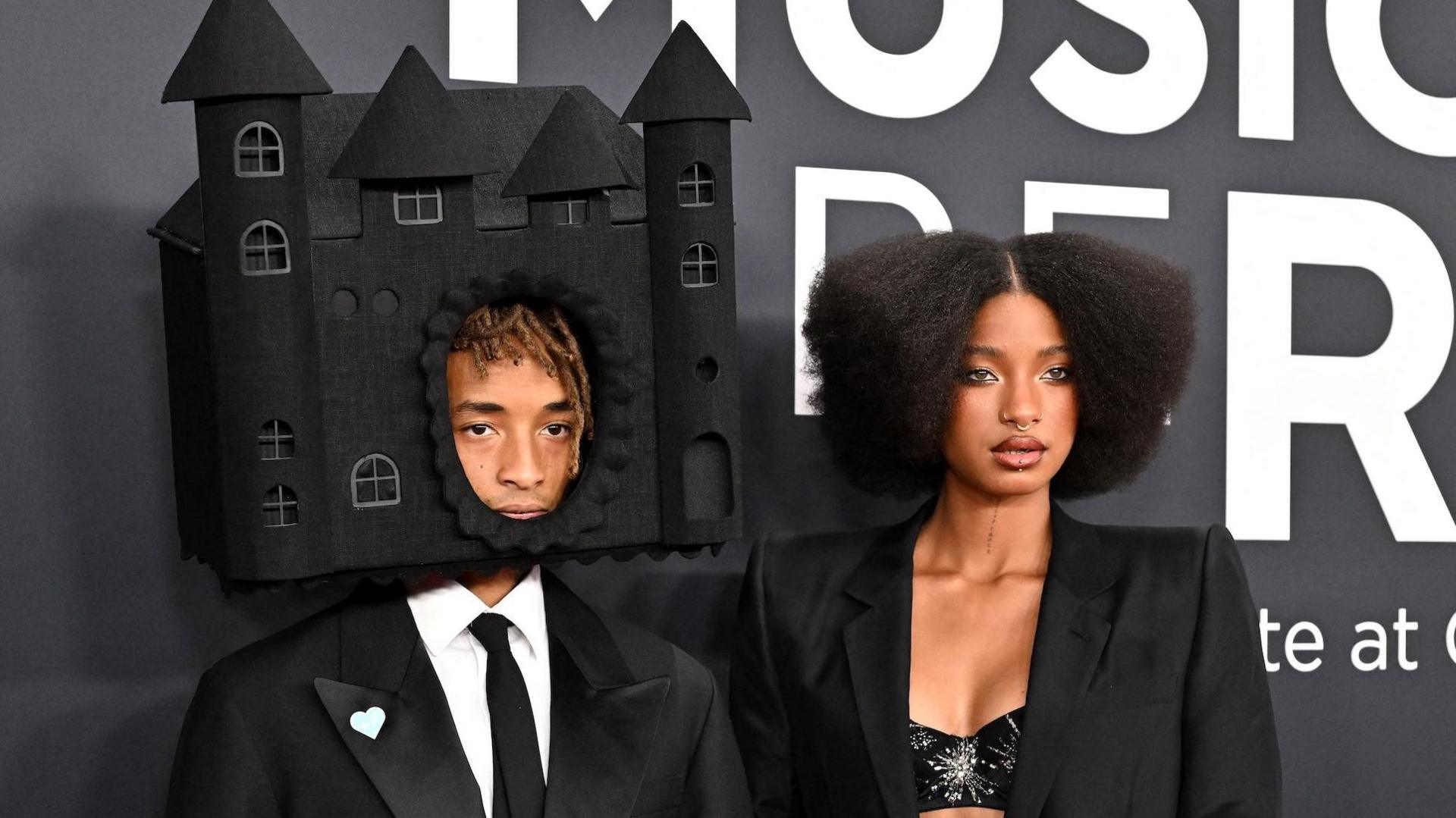 Jaden Smith, with his head inside a house-shaped hat, and his sister Willow Smith on the red carpet