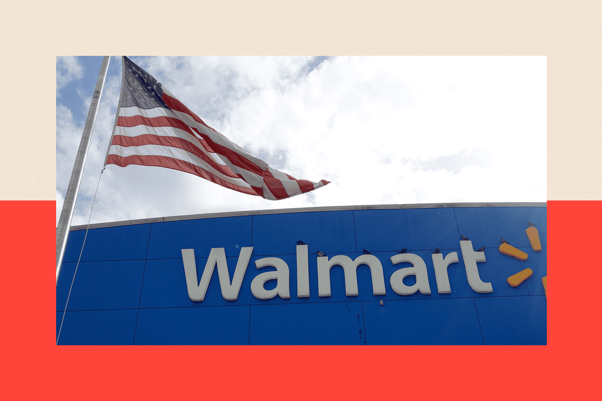 A close up of a Walmart store with a American flag flying in front of it