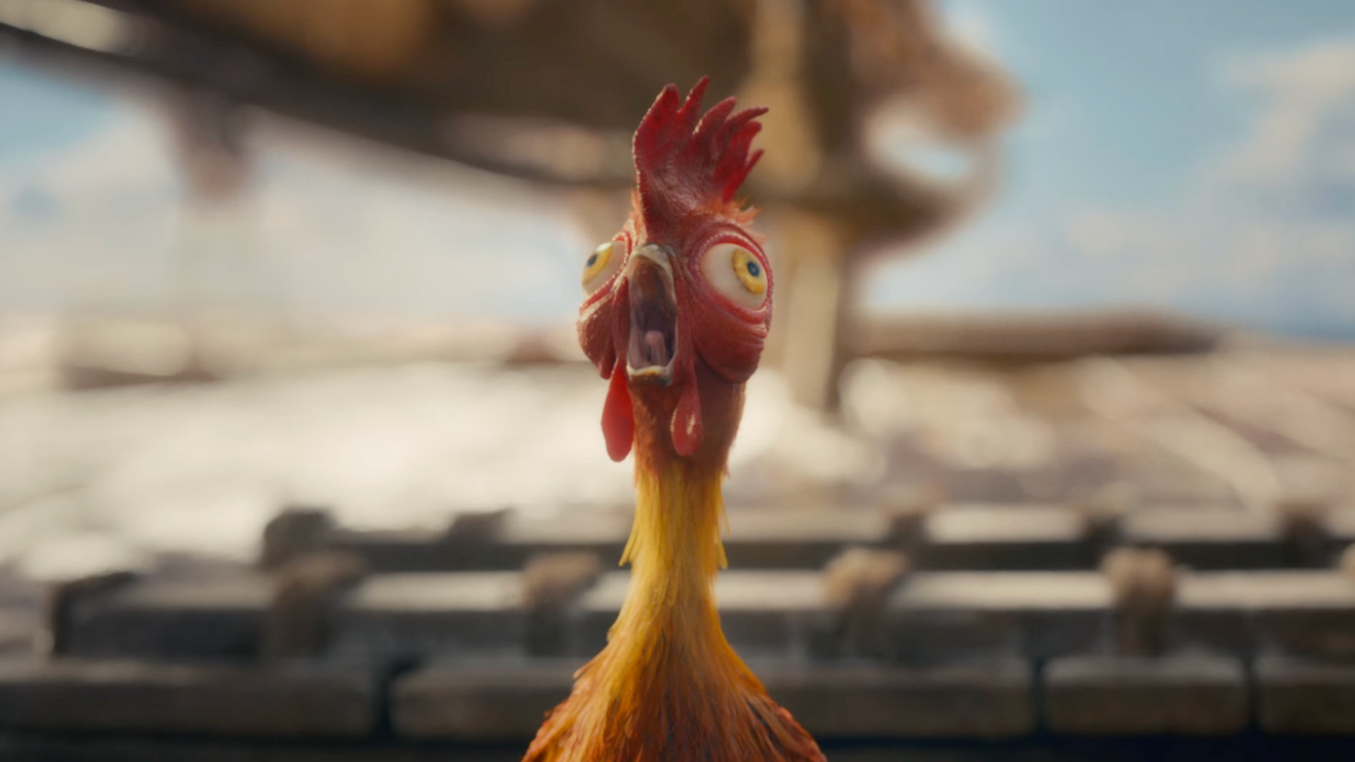 Screengrab from the trailer showing an animated rooster with a orange body, yellow next and red head. It's eyes and mouth are wide open. 