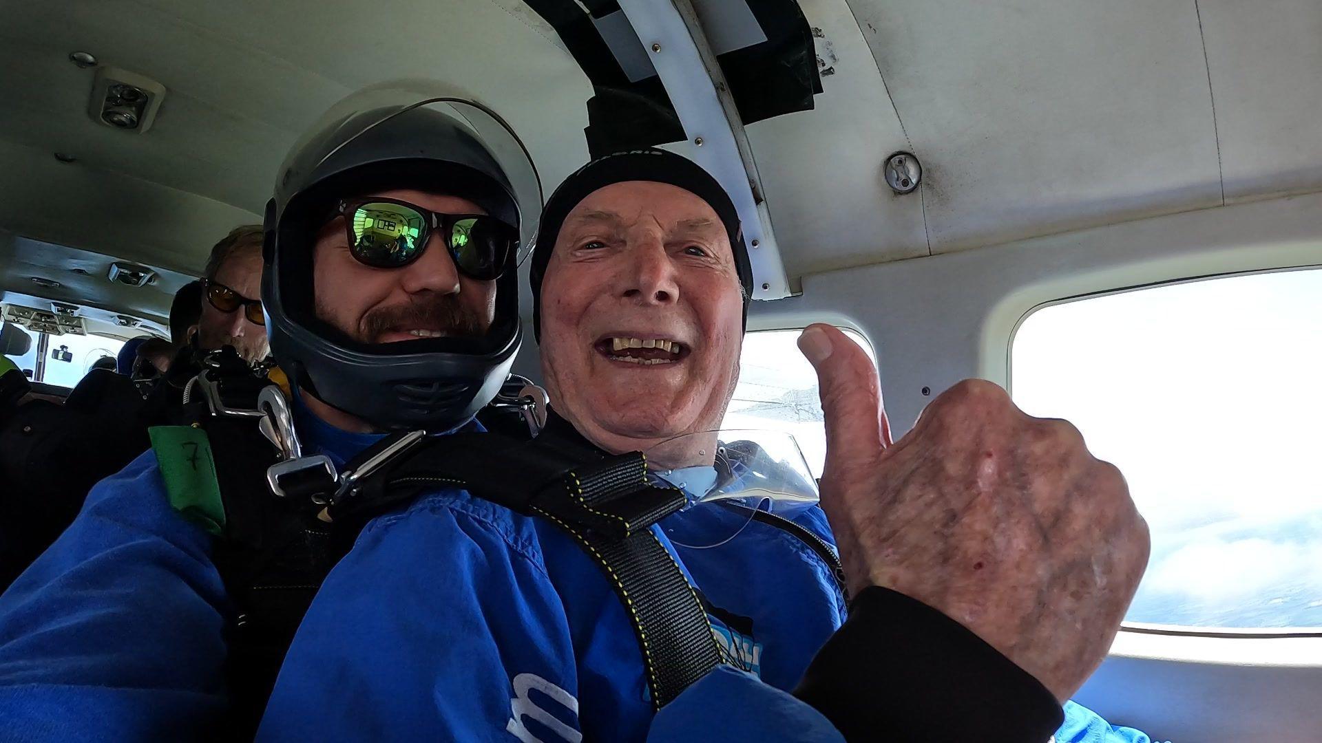 James Mckellar, 88, with his skydiving partner in the plane before the jump