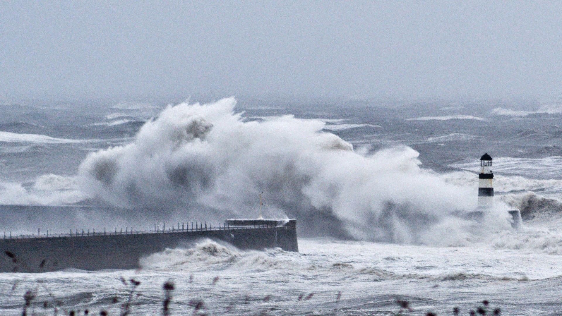 High waves lashing a lighthouse near the ncoast