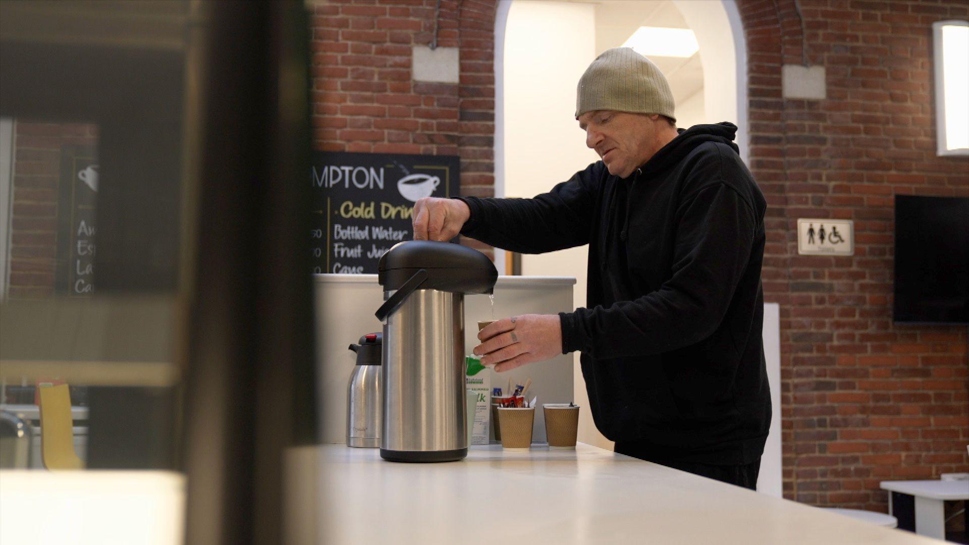 Anthony Grant pours himself a drink at a warm bank in east Leeds