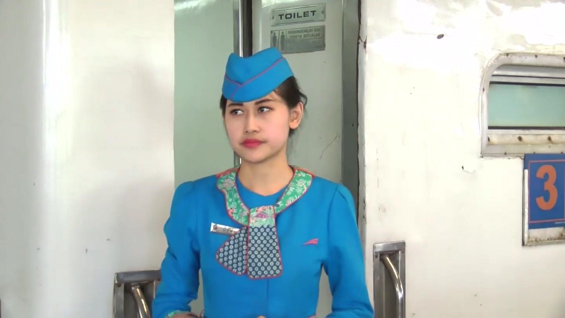 Ticket woman in front of train