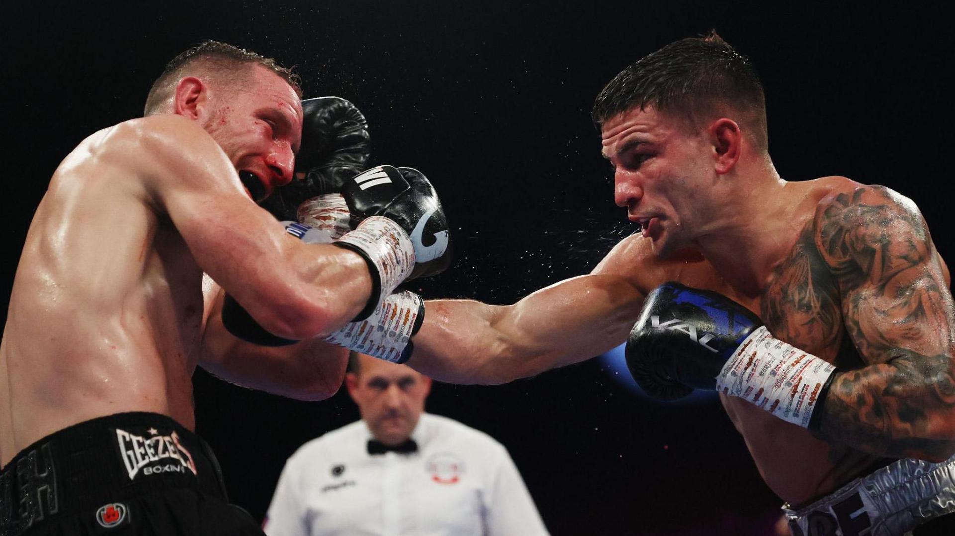 Sam Noakes punches Ryan Walsh during their contest at Wembley Arena