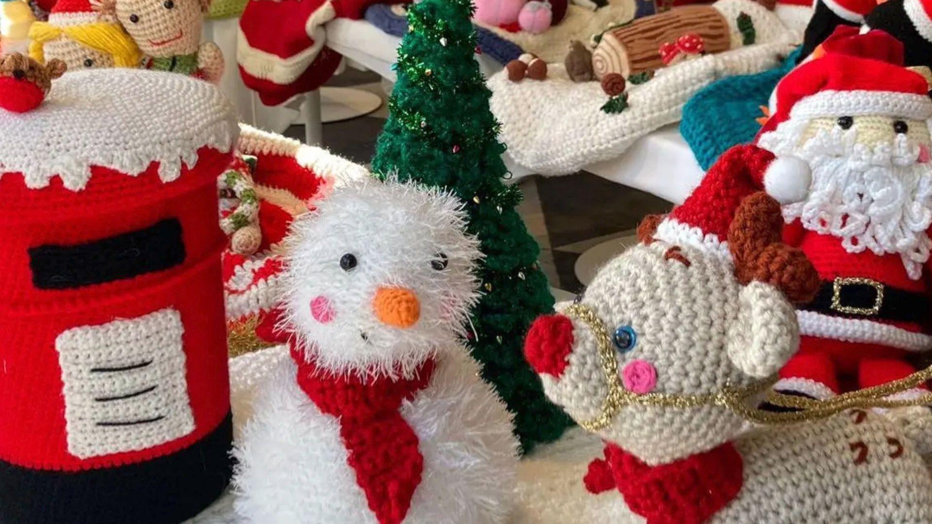 Colourful knitted Santa Claus, reindeer, snowmen, cakes and Christmas trees.