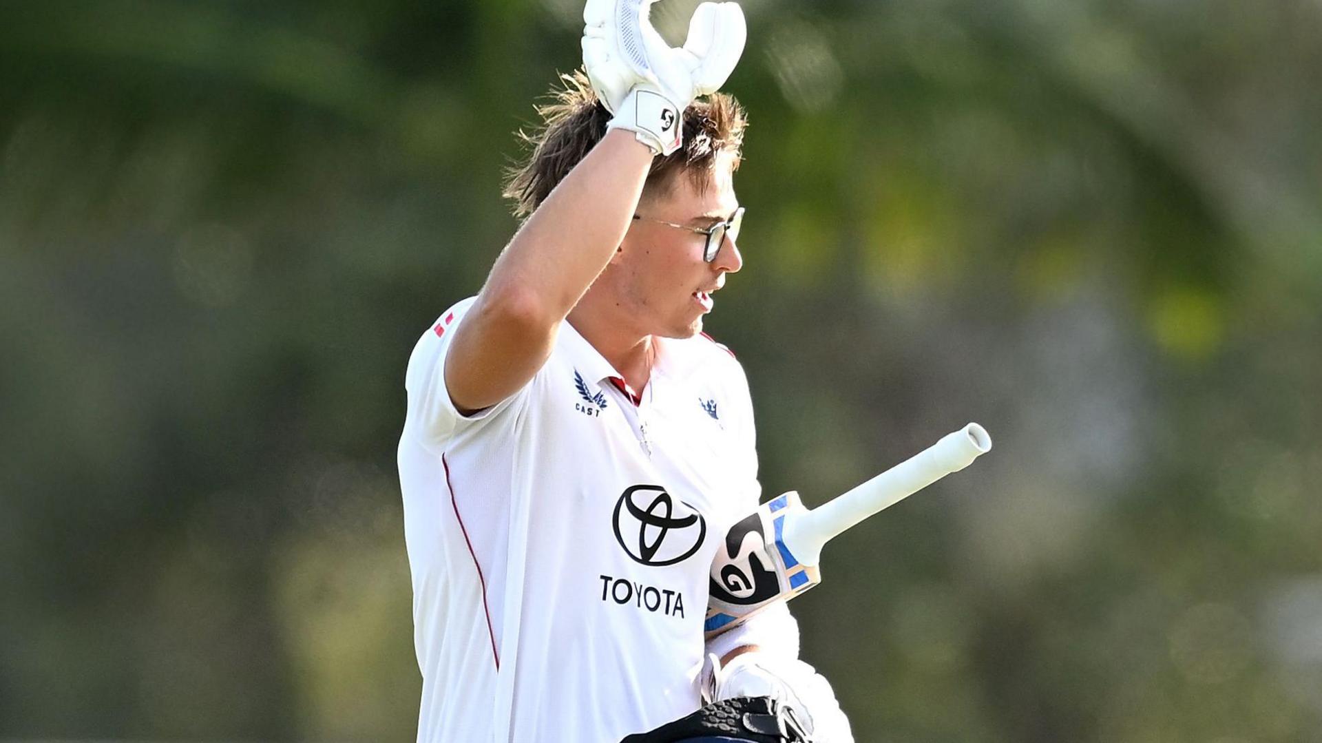 Asa Tribe celebrates scoring a century for England Lions while on tour in Australia over the winter.