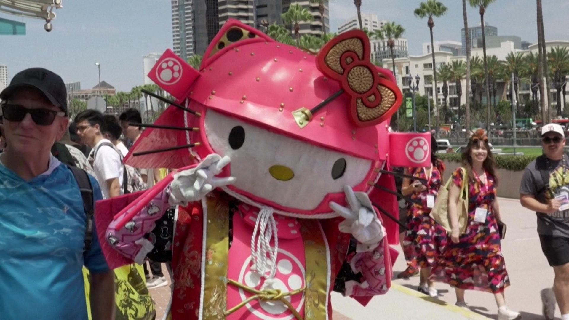 a Hello Kitty samurai costume featuring a bright pink helmet with a prominent bow