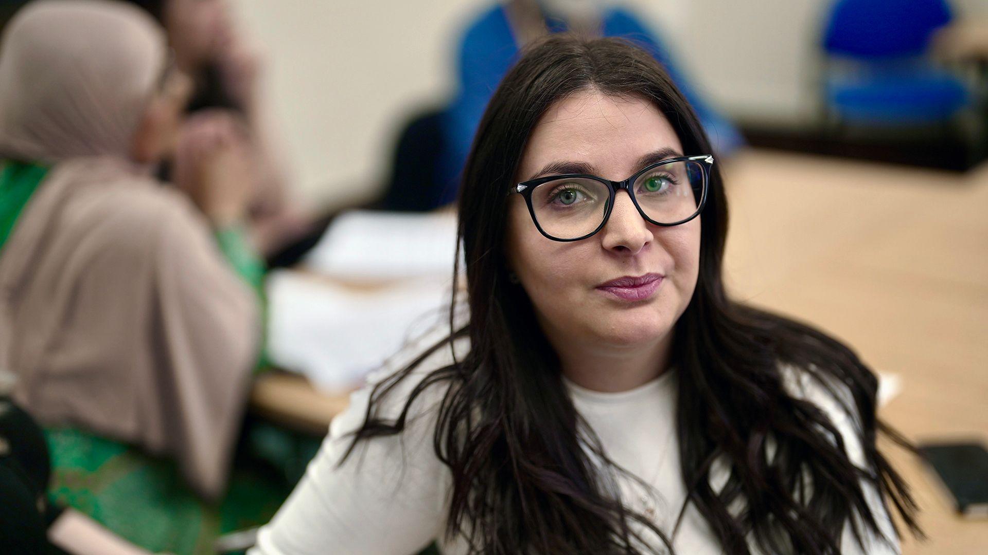 Cintia, a social worker, in the office where she has received additional training 