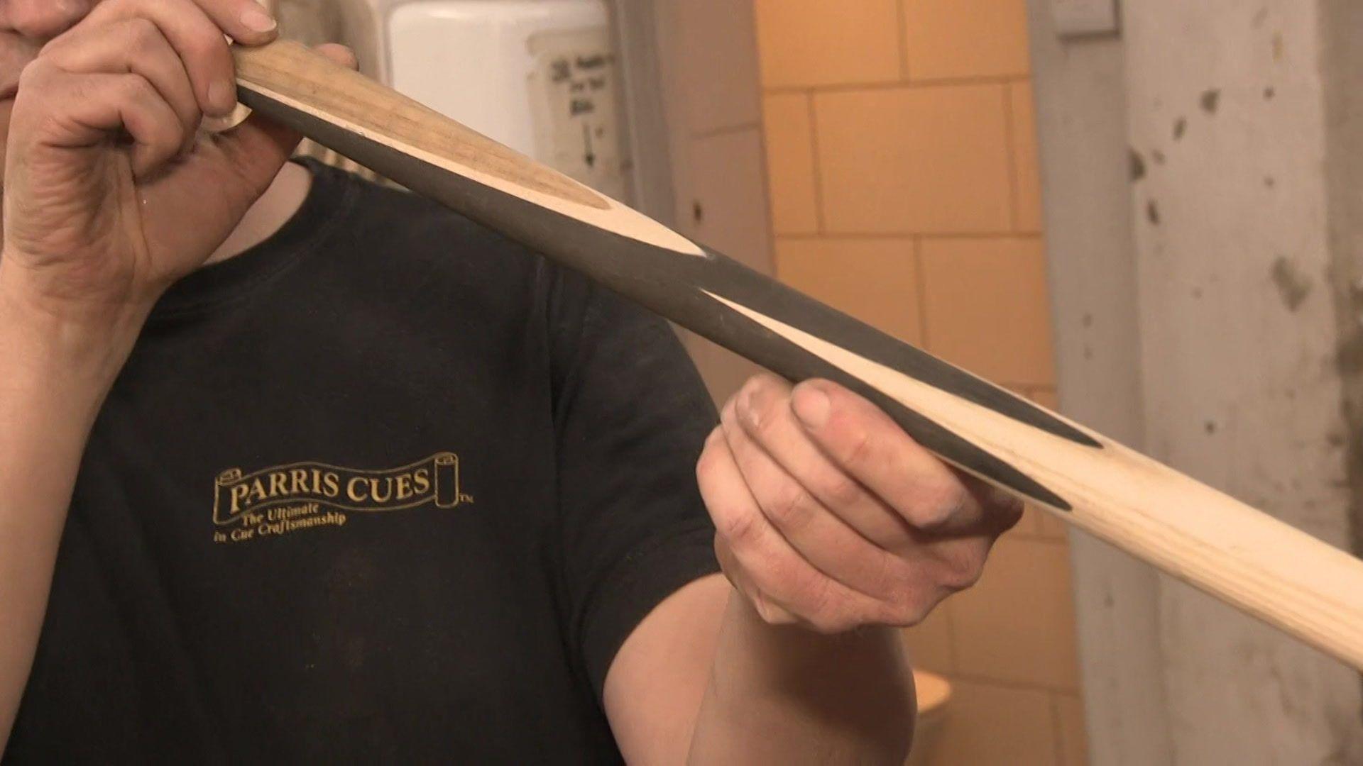 A workshop employee inspects a new snooker cue being designed for Ronnie O'Sullivan at Parris Cues in South East London.