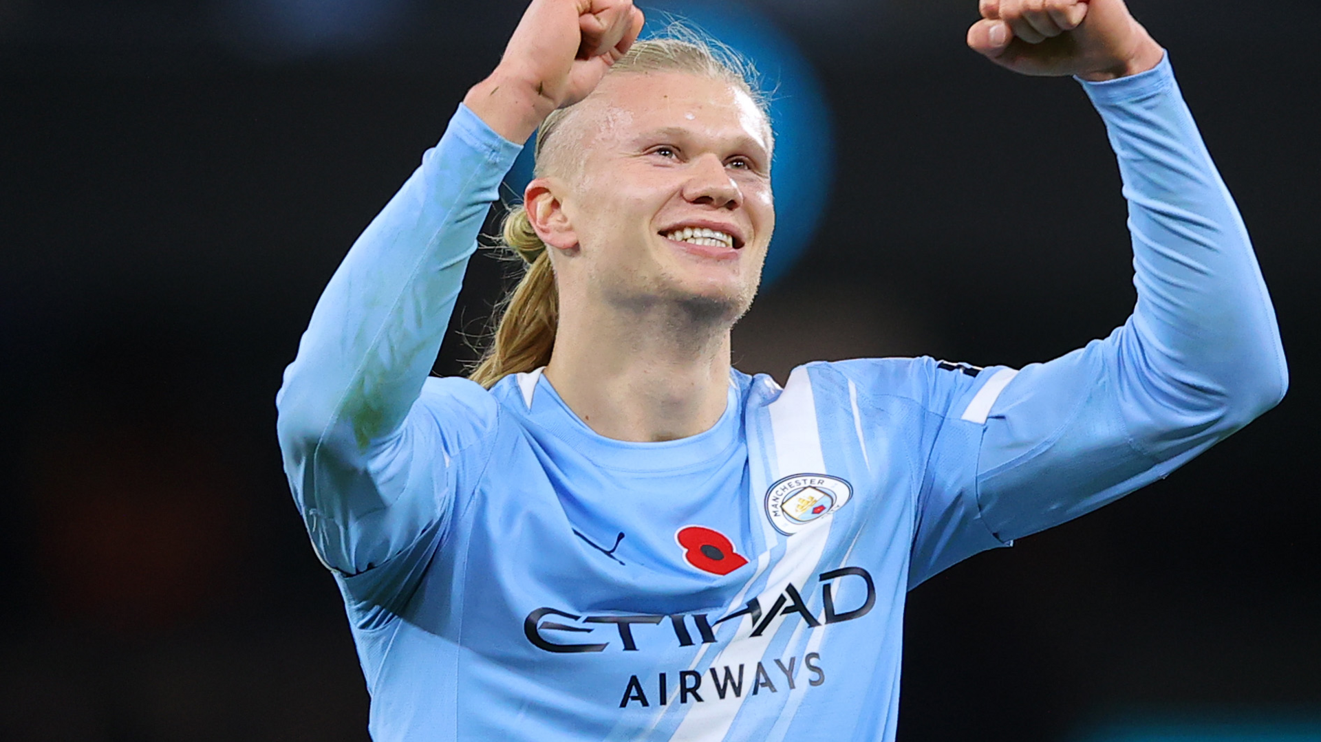 Erling Haaland celebrates in a Manchester City shirt