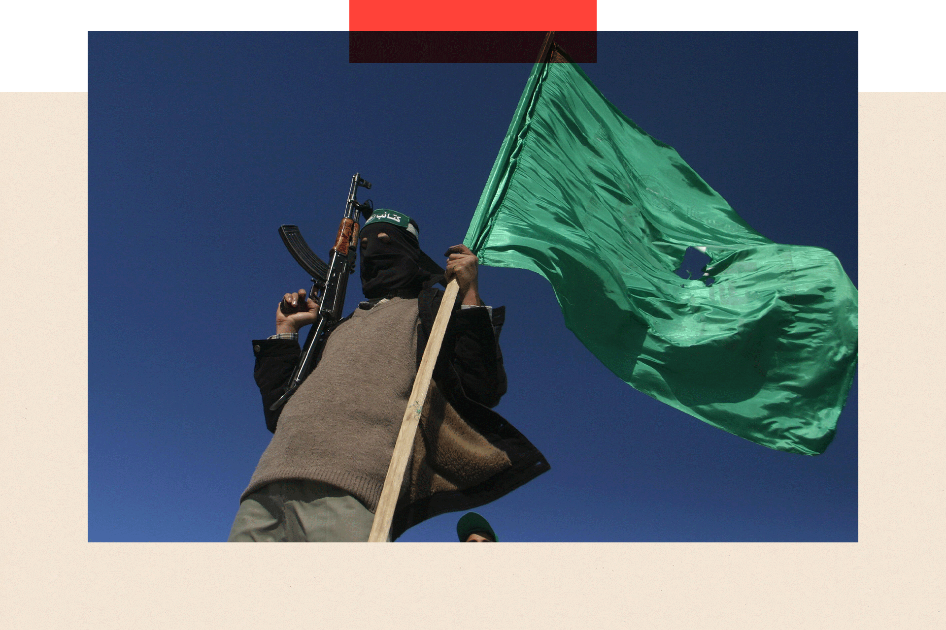 A Hamas militant waves his party's flag