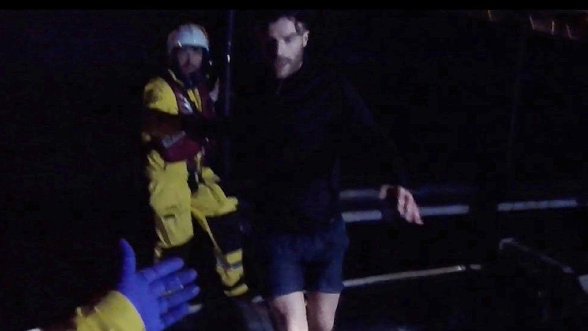 Radio DJ Jordan North being escorted from a lifeboat on the River Thames by rescuers